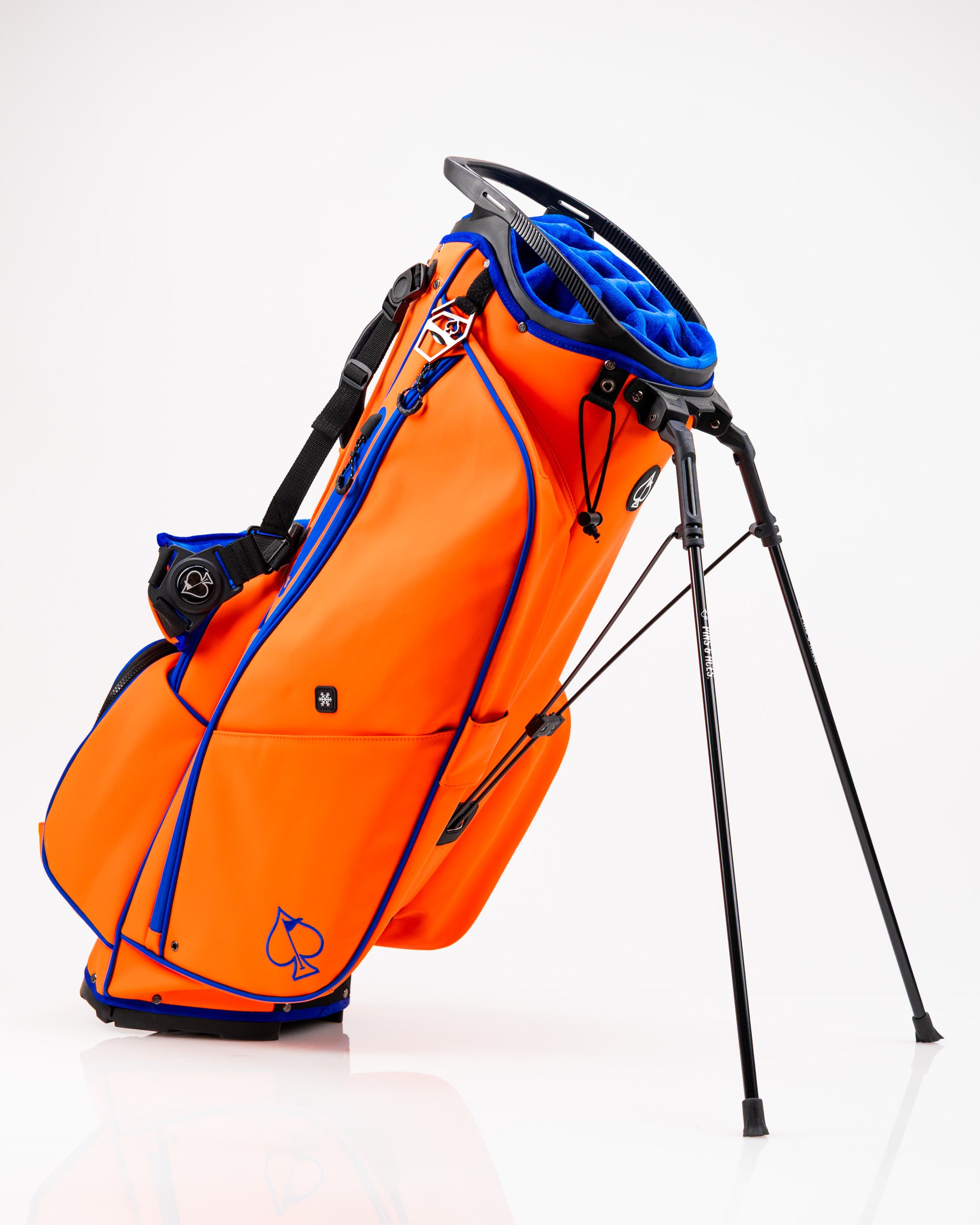 Bold orange golf bag with blue accents and a stand, designed for golfers seeking style and functionality on the course.
