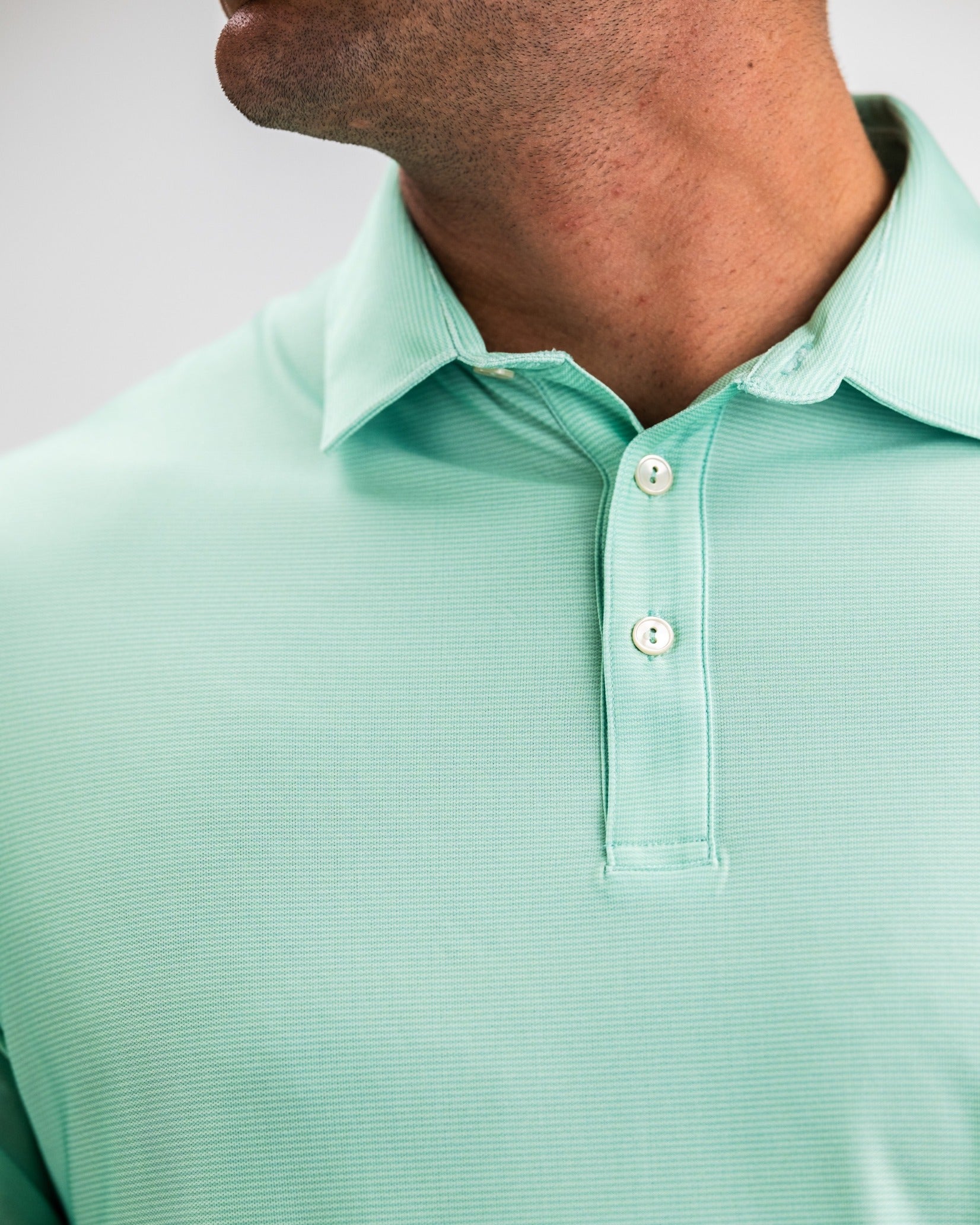 Player Preferred Polo in spearmint stripes features a classic collar and button placket, ideal for stylish golfers.
