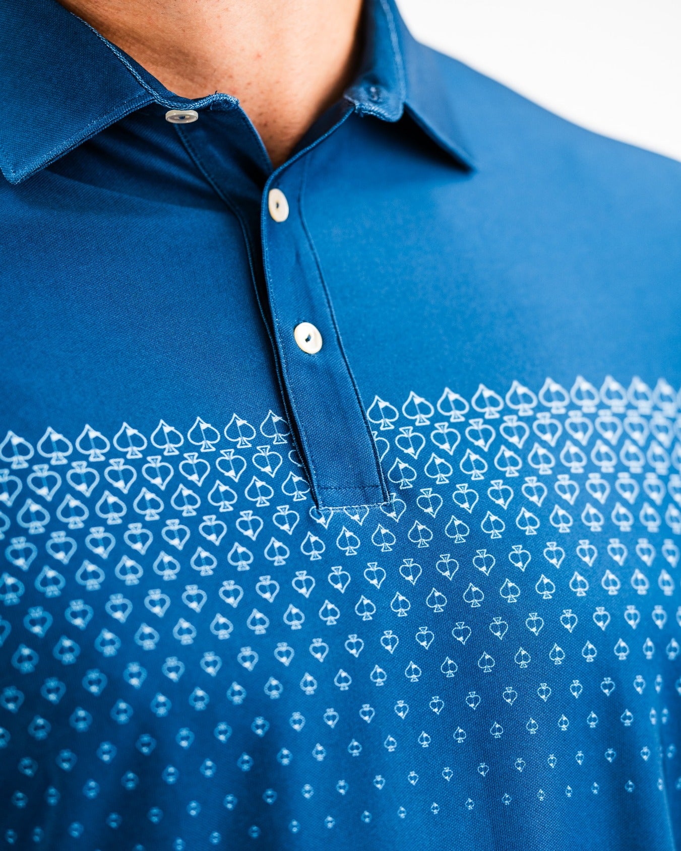 Navy Player Preferred Polo featuring a spade fade design with a gradient pattern of spade shapes across the chest.