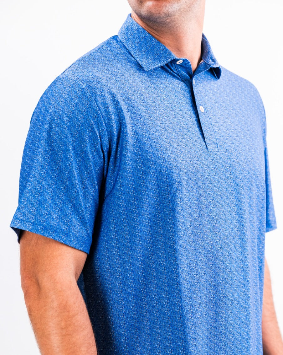 Men's Player Preferred Polo in Cosmic Swirl features a vibrant blue pattern, perfect for stylish golf outings.