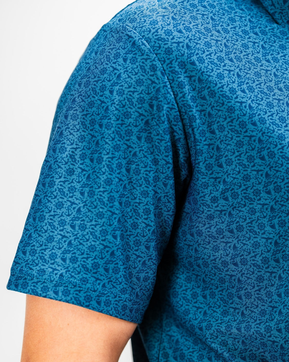 Player Preferred Polo - The Mariner features a vibrant blue pattern, perfect for golfers seeking stylish performance on the course.