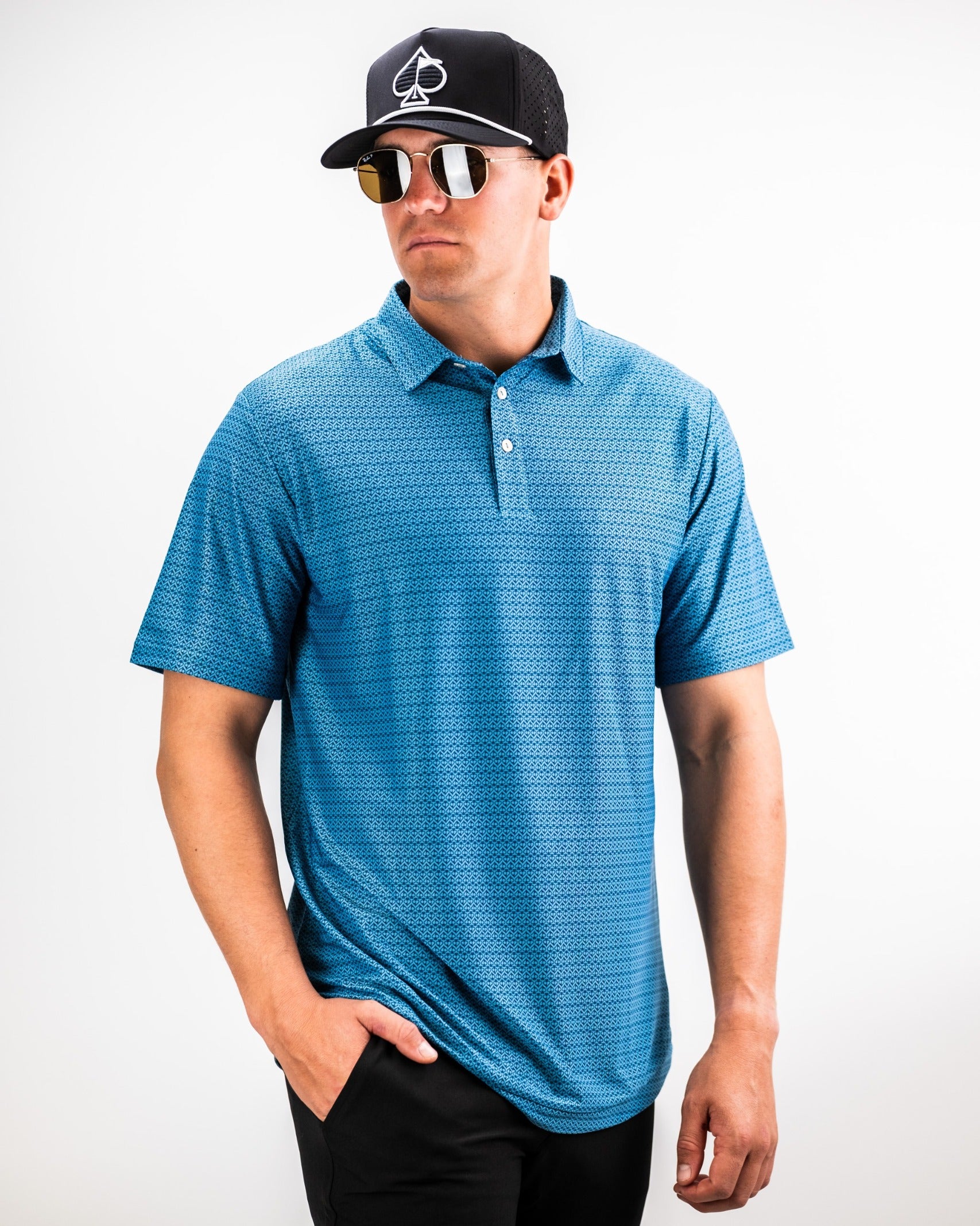 Men's Player Preferred Polo in Ocean Spade, featuring a stylish pattern, paired with sunglasses and a cap for a bold golf look.