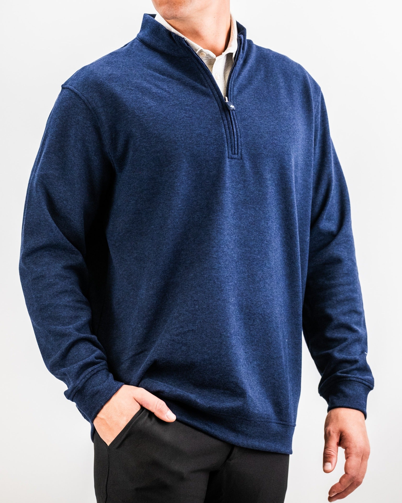 Heathered navy pullover with a quarter zip, designed for comfort and style on the golf course. Perfect for layering.