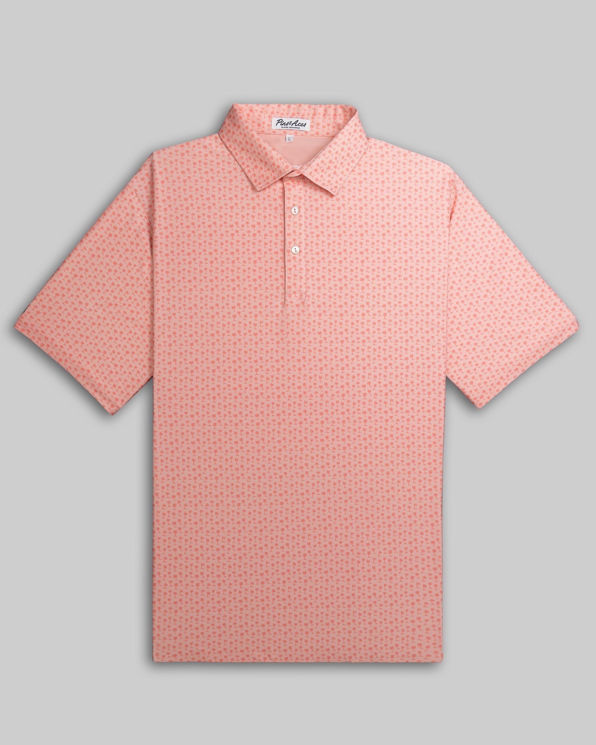 Player Preferred Polo in coral with a palm pattern, designed for golfers seeking stylish and comfortable apparel on the course.