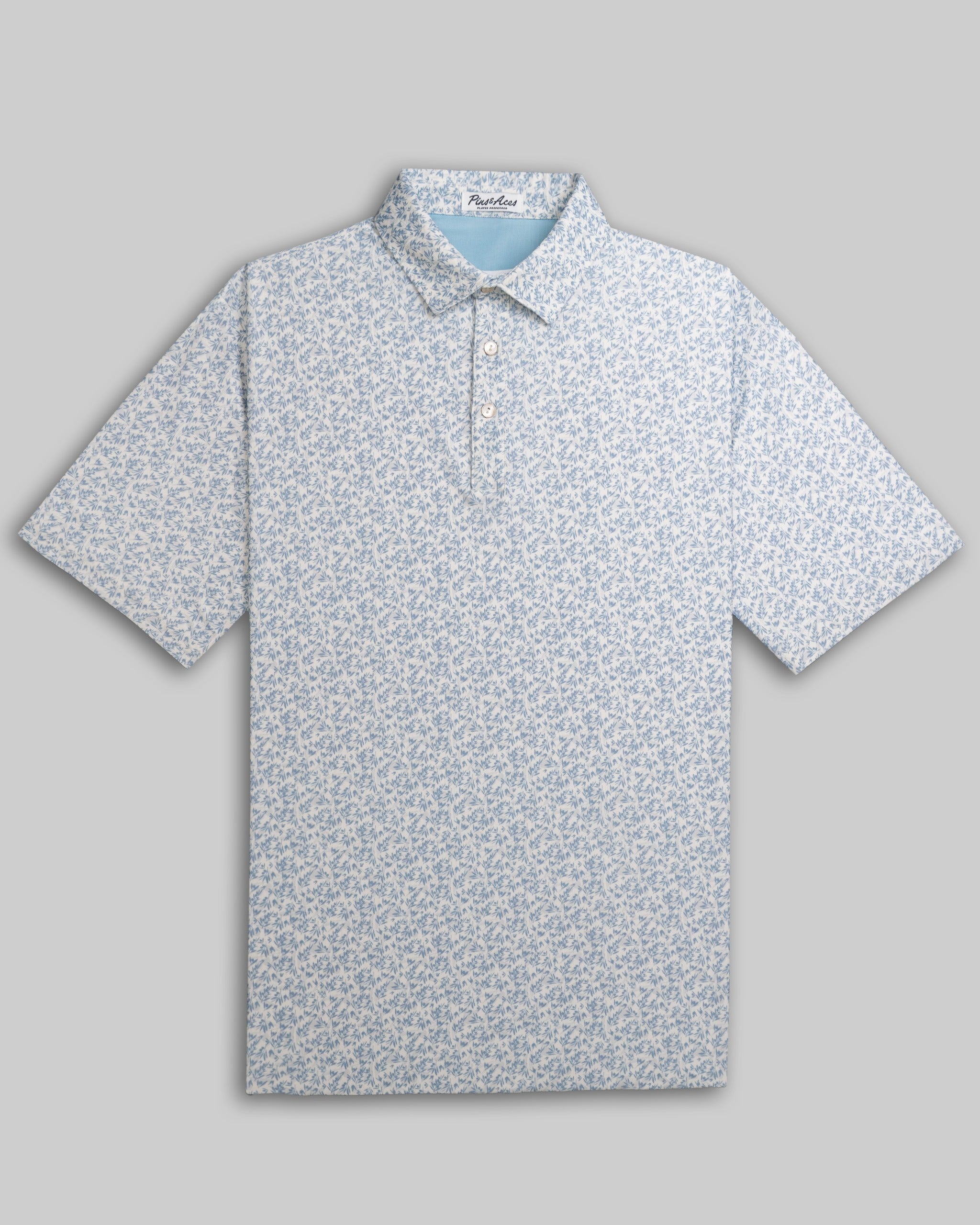 Olive Groves Player Preferred Polo featuring a light blue floral pattern, designed for stylish golfers seeking comfort.