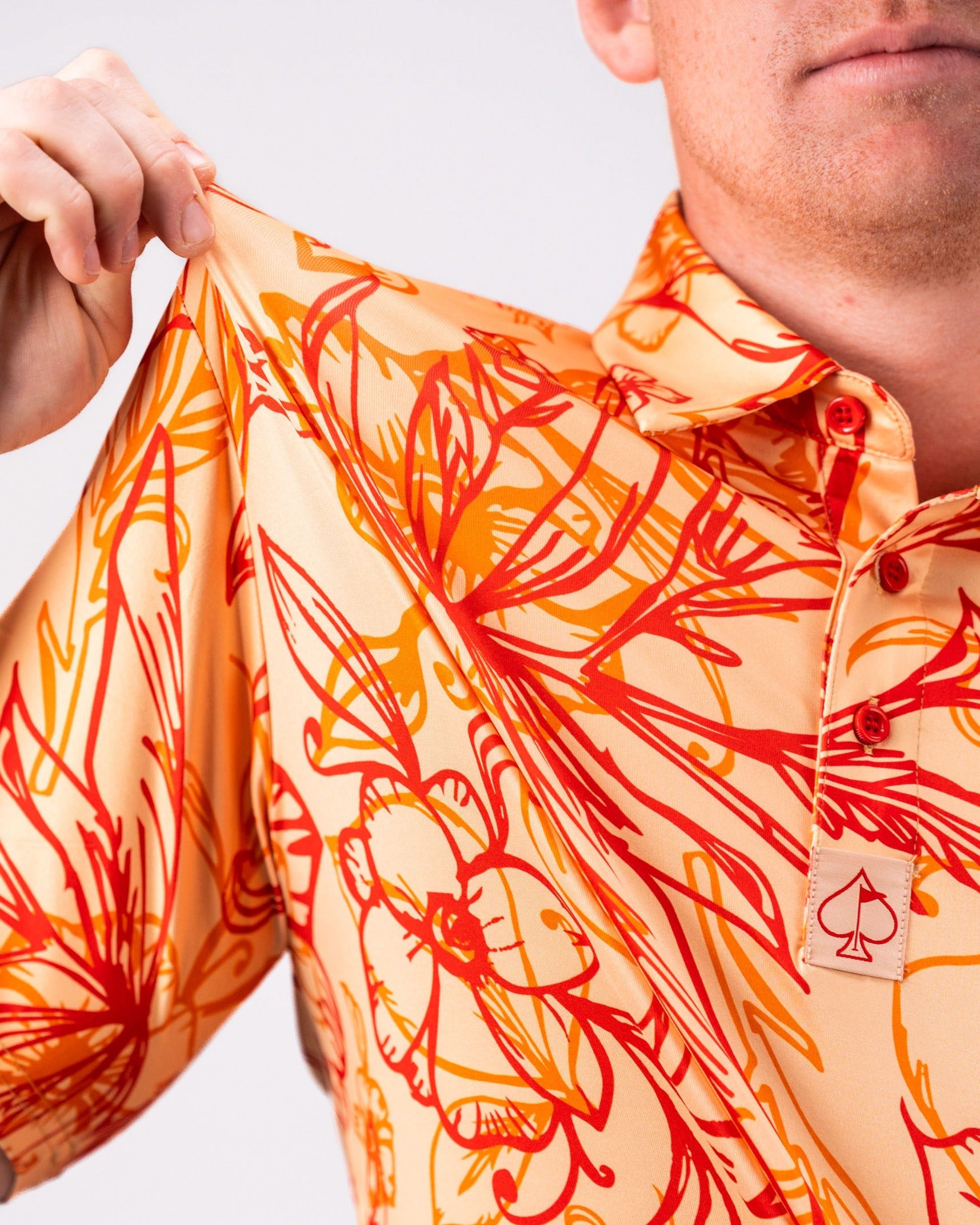 Bold golf shirt featuring a vibrant sunburst design with floral and abstract patterns, perfect for standing out on the course.