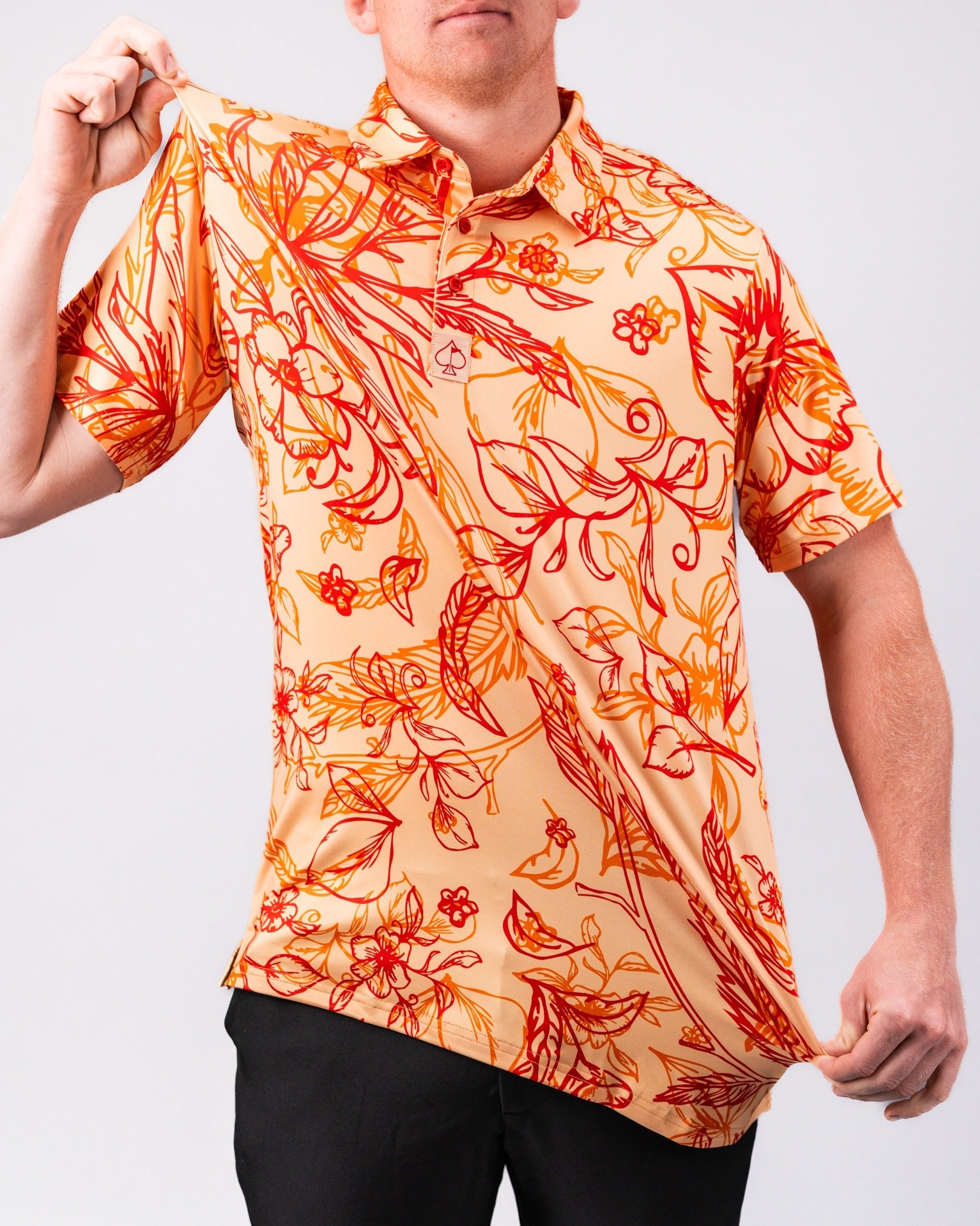 Bold golf shirt featuring a vibrant sunburst floral pattern in orange and red tones, perfect for standing out on the course.