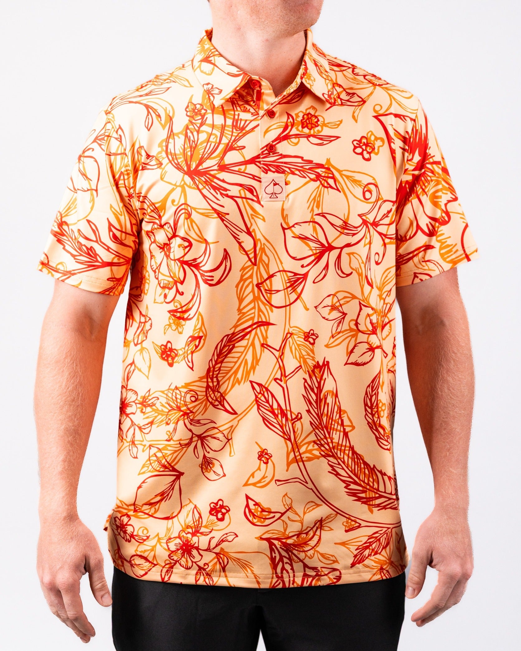Bold floral-patterned golf shirt in warm sunburst colors, perfect for making a statement on the course.