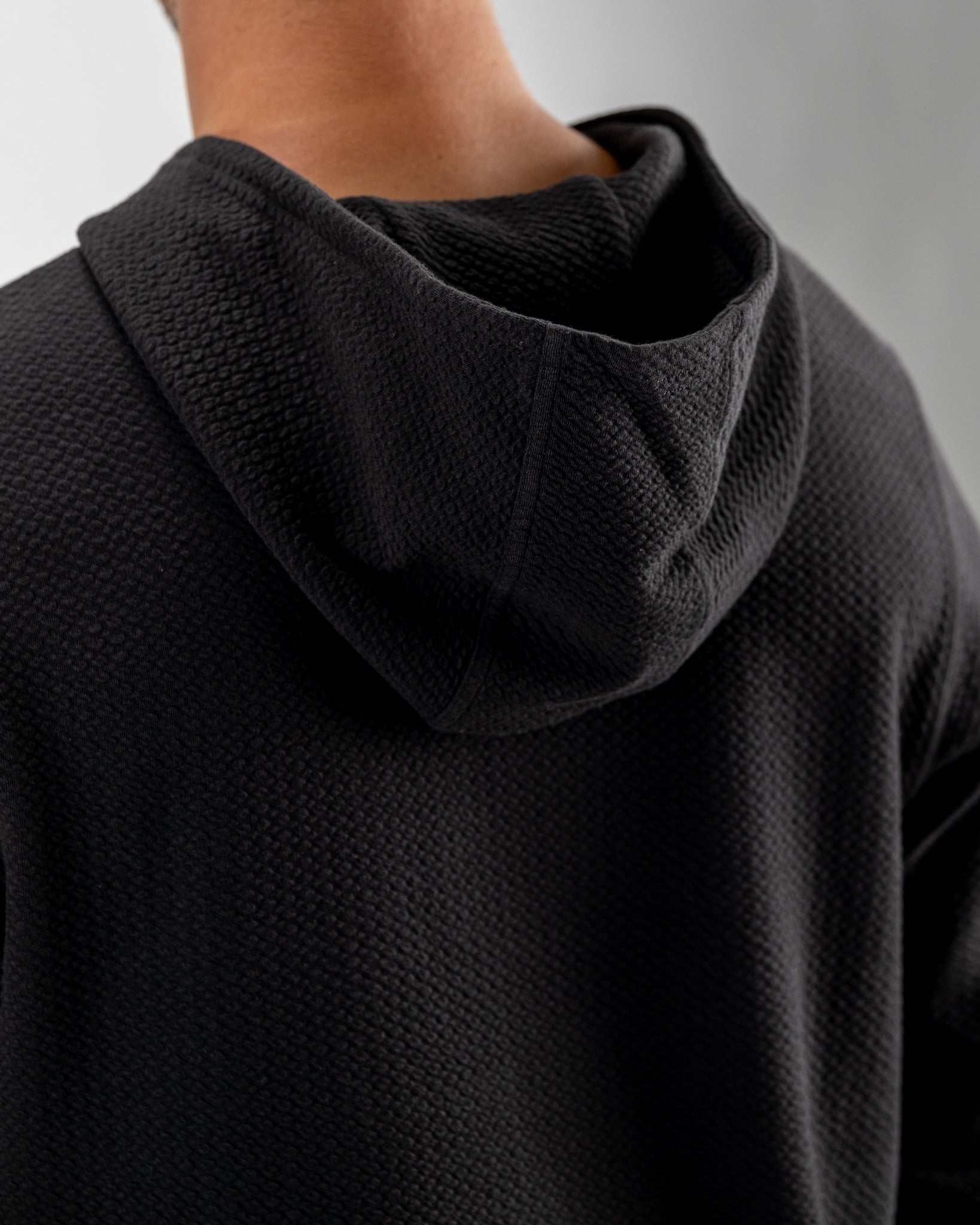 Player Preferred Waffle Knit Hoodie in Obsidian features a textured design and a cozy hood, perfect for stylish comfort on the course.