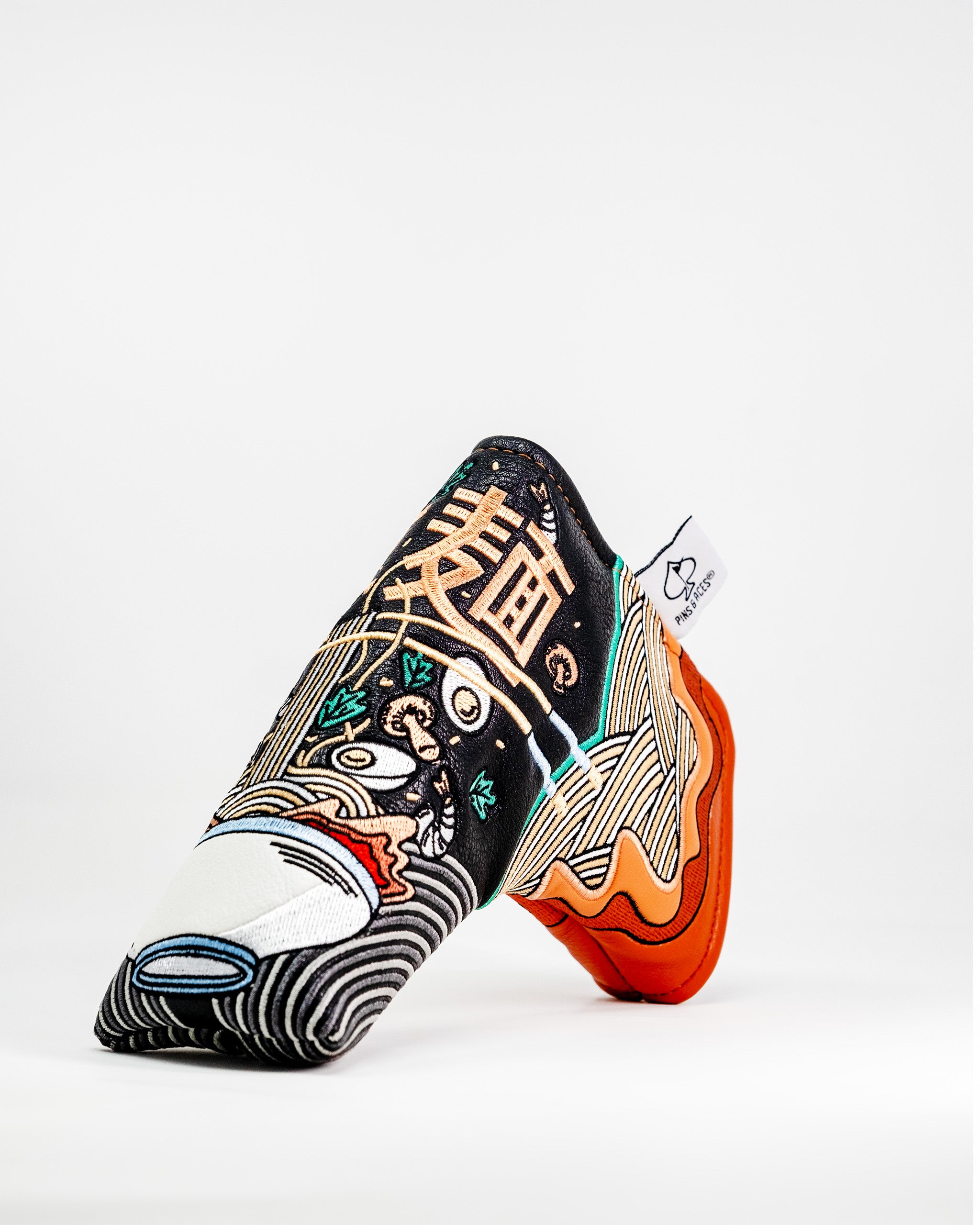 Bold ramen-themed blade putter cover featuring intricate embroidery and vibrant colors, perfect for stylish golfers.