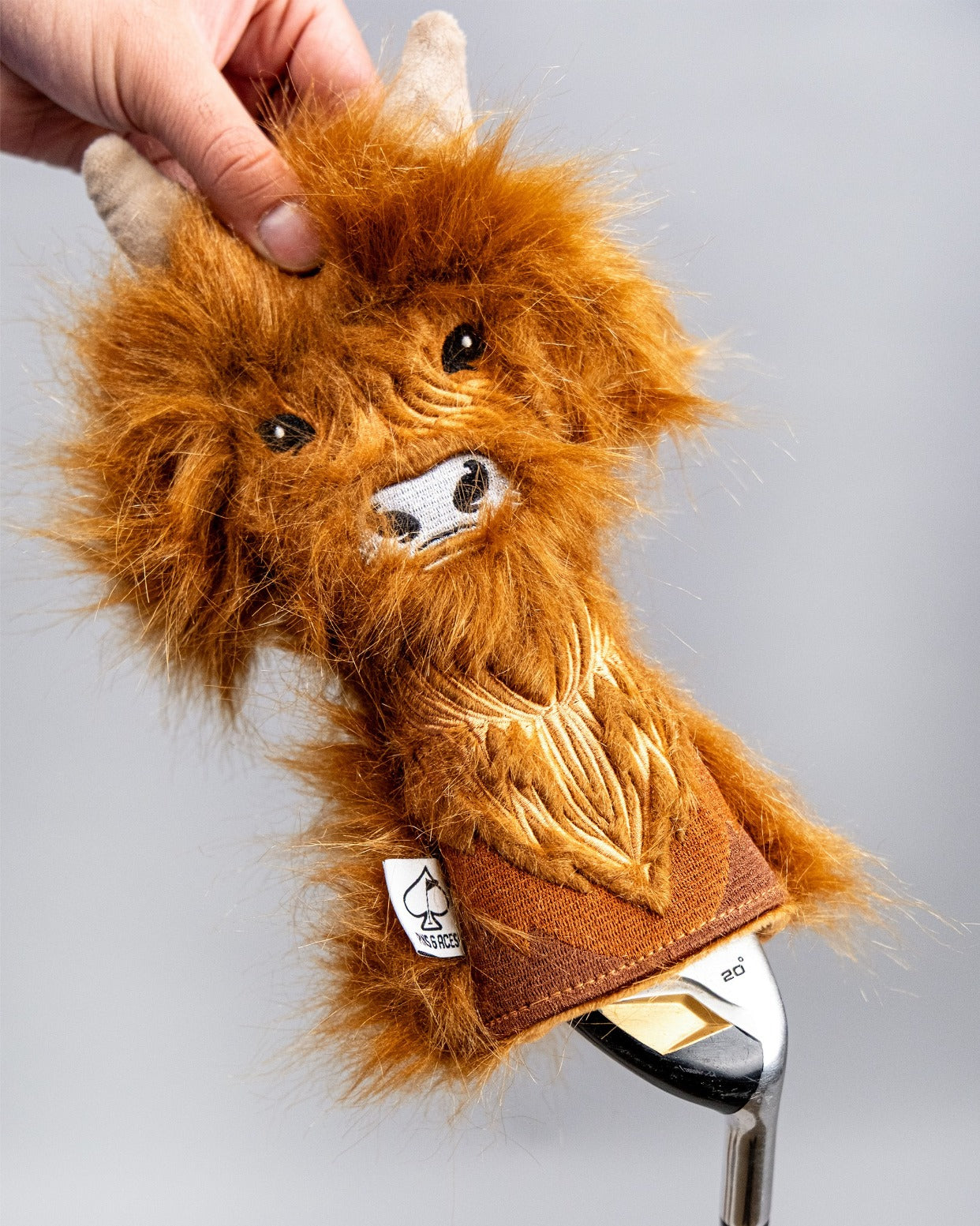 Highland cow hybrid golf headcover with fluffy orange fur and detailed facial features, designed for a unique style on the course.