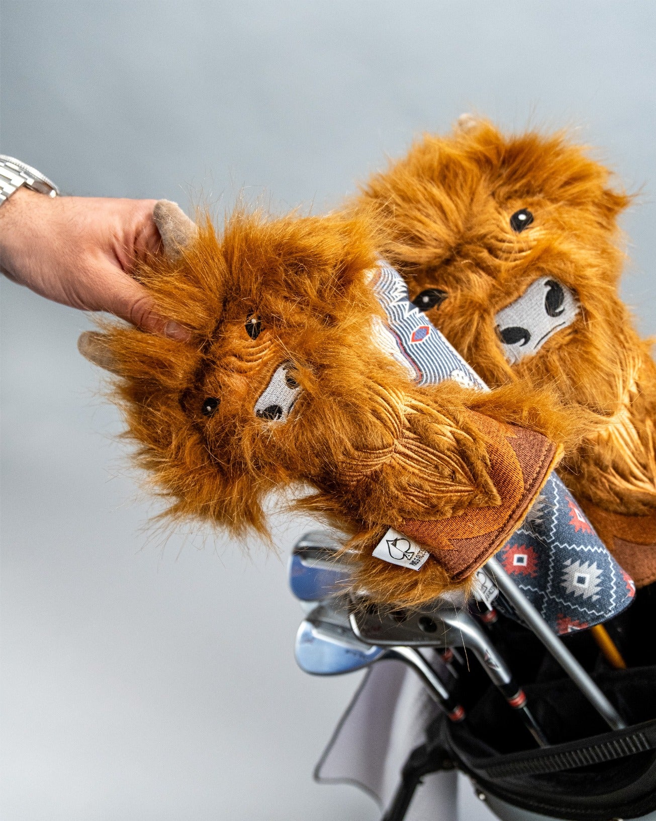 Highland cow hybrid golf headcovers featuring a fluffy design and unique patterns, adding personality to any golf bag.