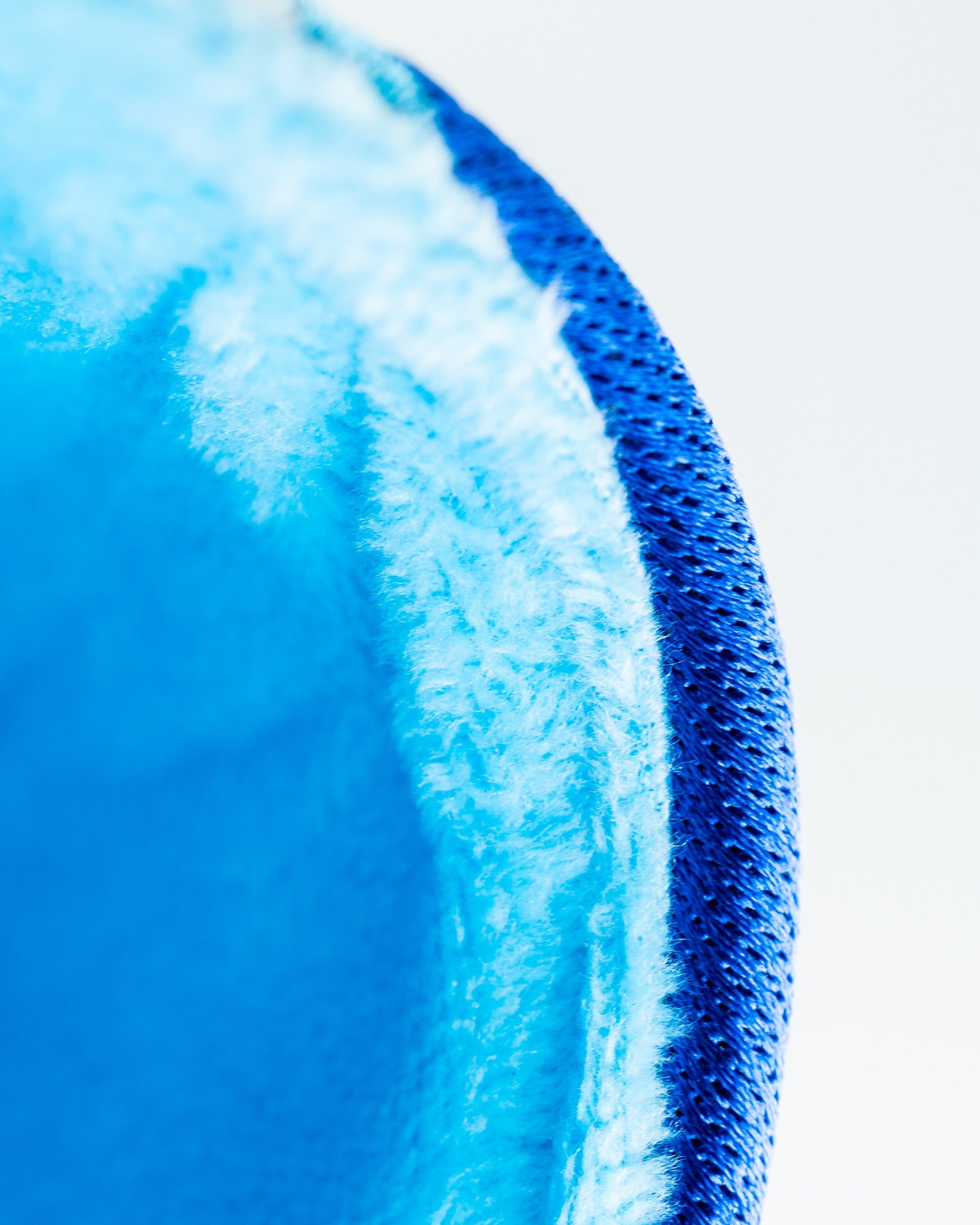 Close-up of the Blucifer driver cover, featuring a vibrant blue exterior and soft, plush interior for protection.