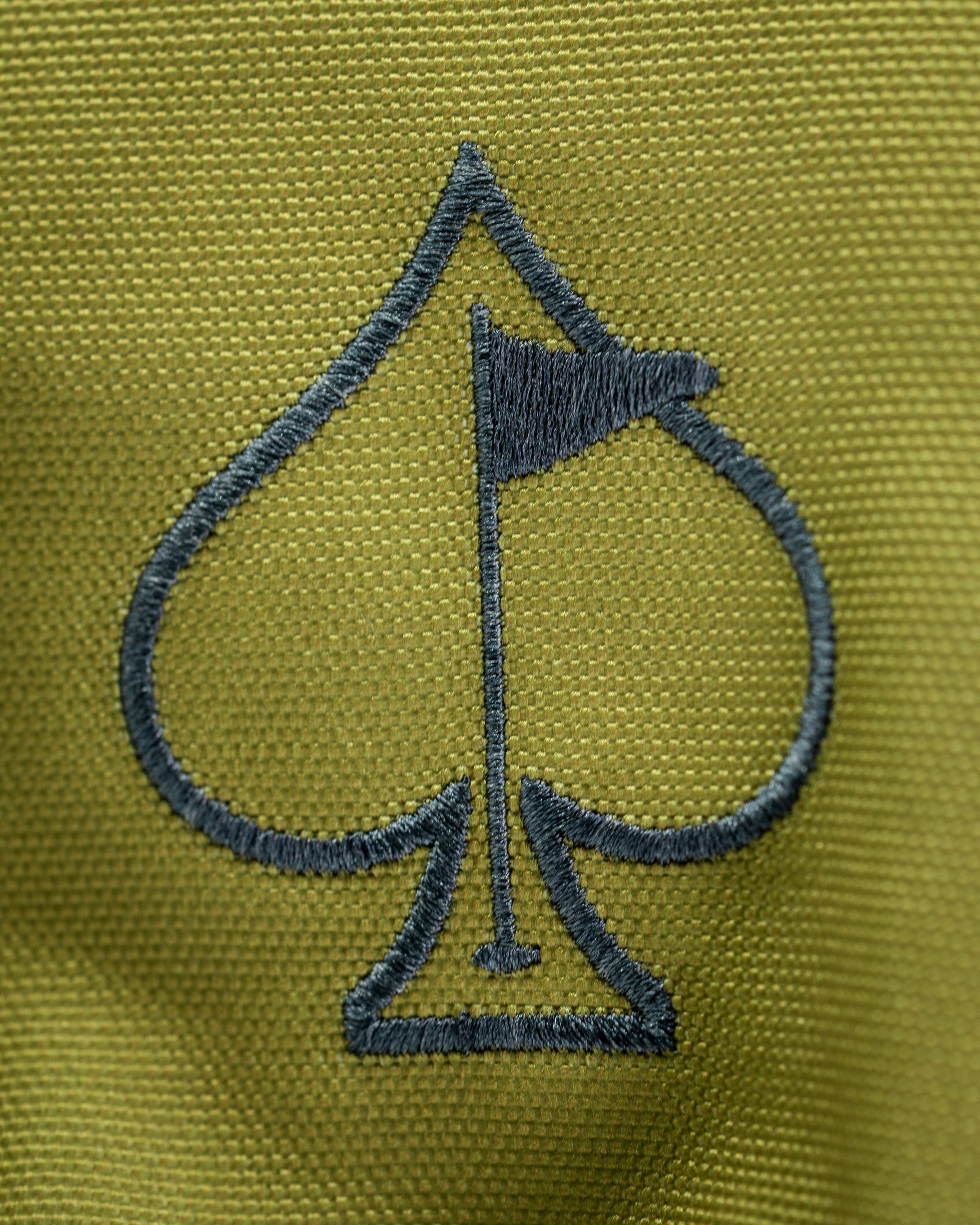 Close-up of the Open Season Mallard driver cover featuring a green fabric with a spade logo and flag design.
