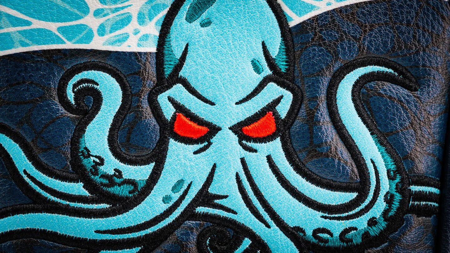 Bold Kraken mallet putter cover featuring an intricately embroidered octopus design with striking red eyes and blue accents.