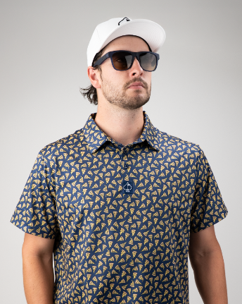 Man wearing a patterned golf shirt featuring pizza slices, paired with sunglasses and a white cap, posing confidently.