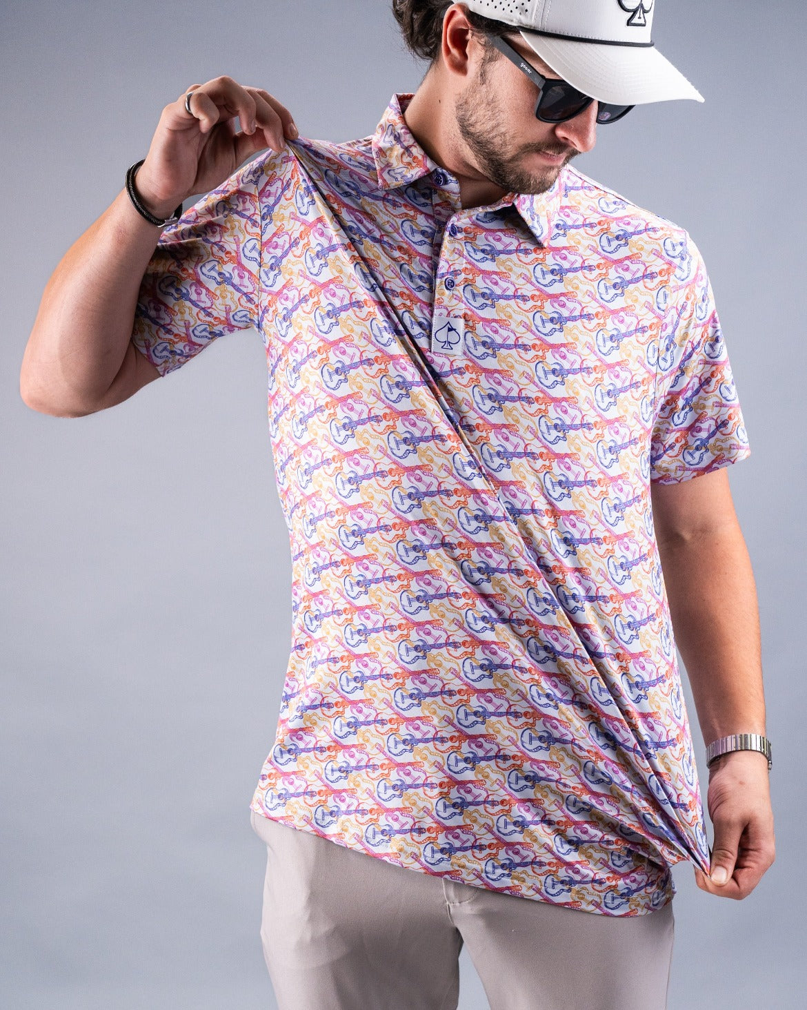 A man showcases a colorful Margaritaville polo shirt featuring a playful tropical design, perfect for casual golf outings.