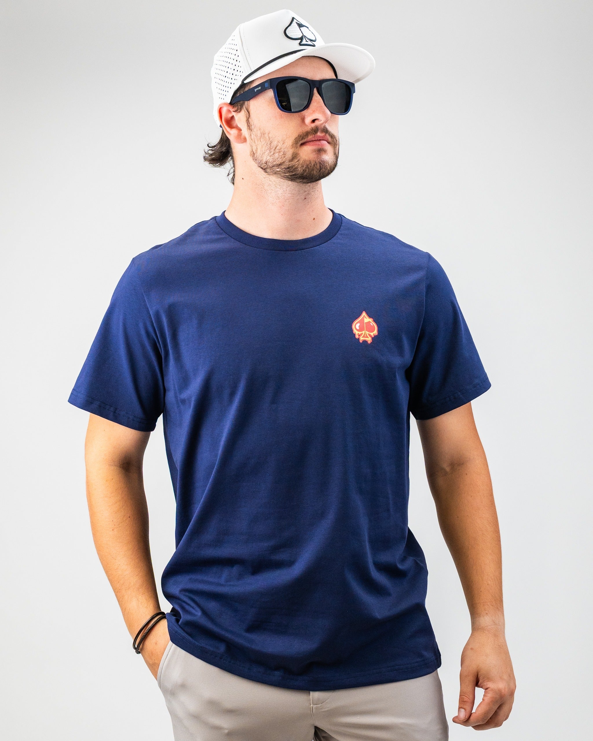 Navy blue t-shirt featuring the Louisiana Hot Sauce logo on the chest, worn by a man with sunglasses and a cap.