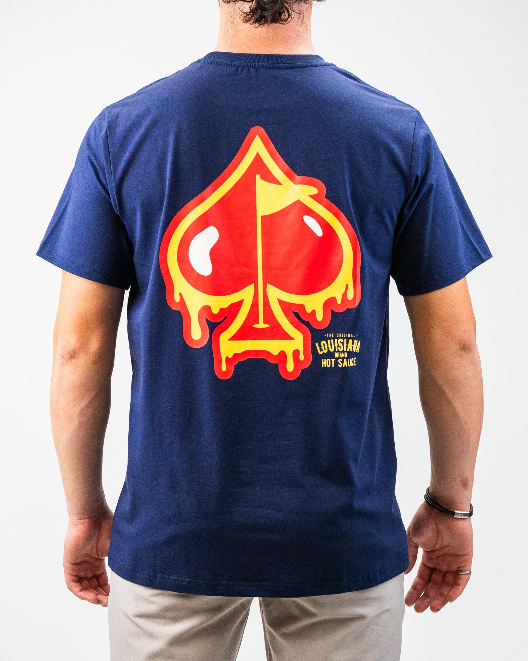 Bold navy tee featuring a vibrant dripping spade graphic inspired by Louisiana Hot Sauce, perfect for standout style on the course.