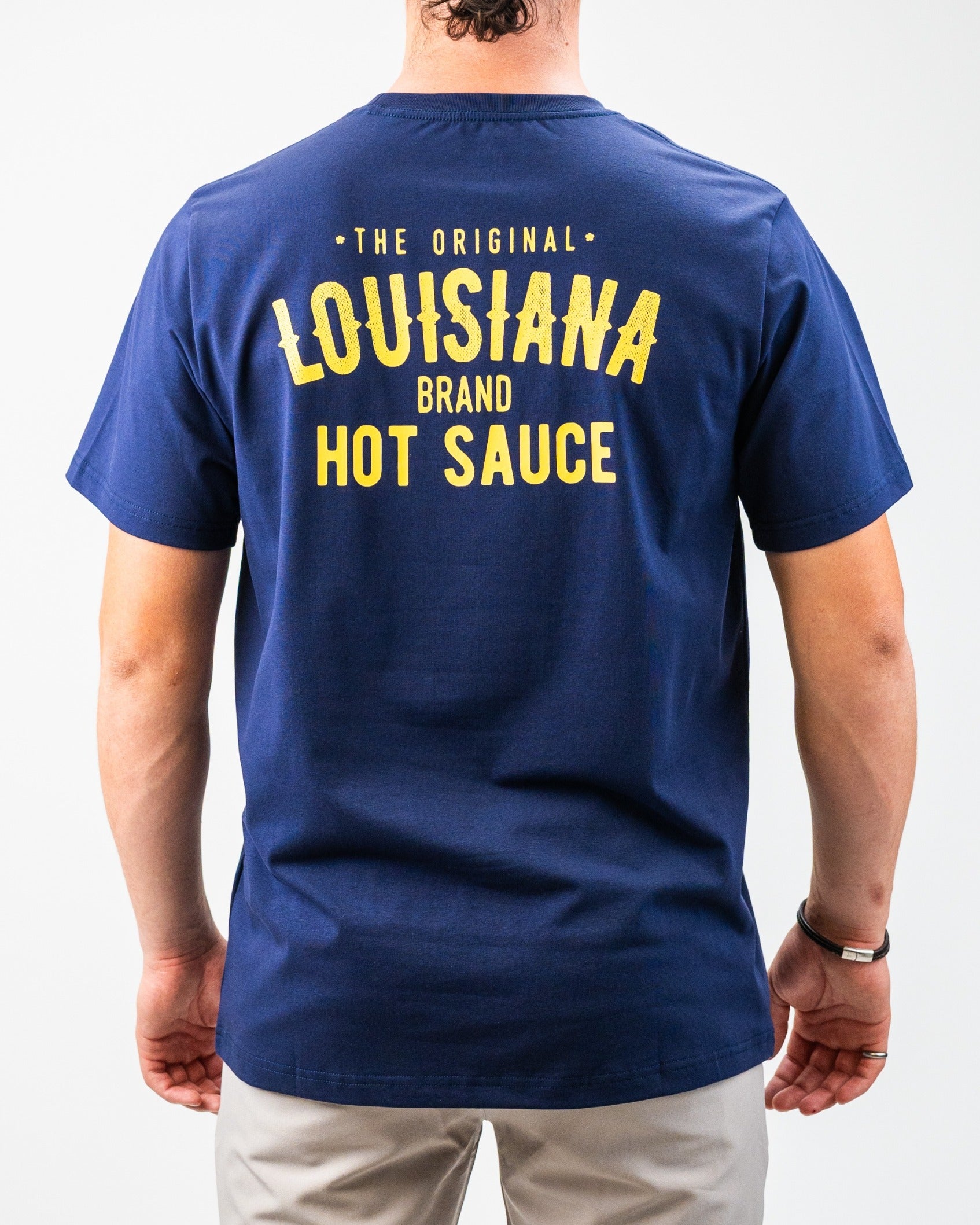 Navy blue t-shirt featuring the Louisiana Hot Sauce logo in bold yellow text on the back.