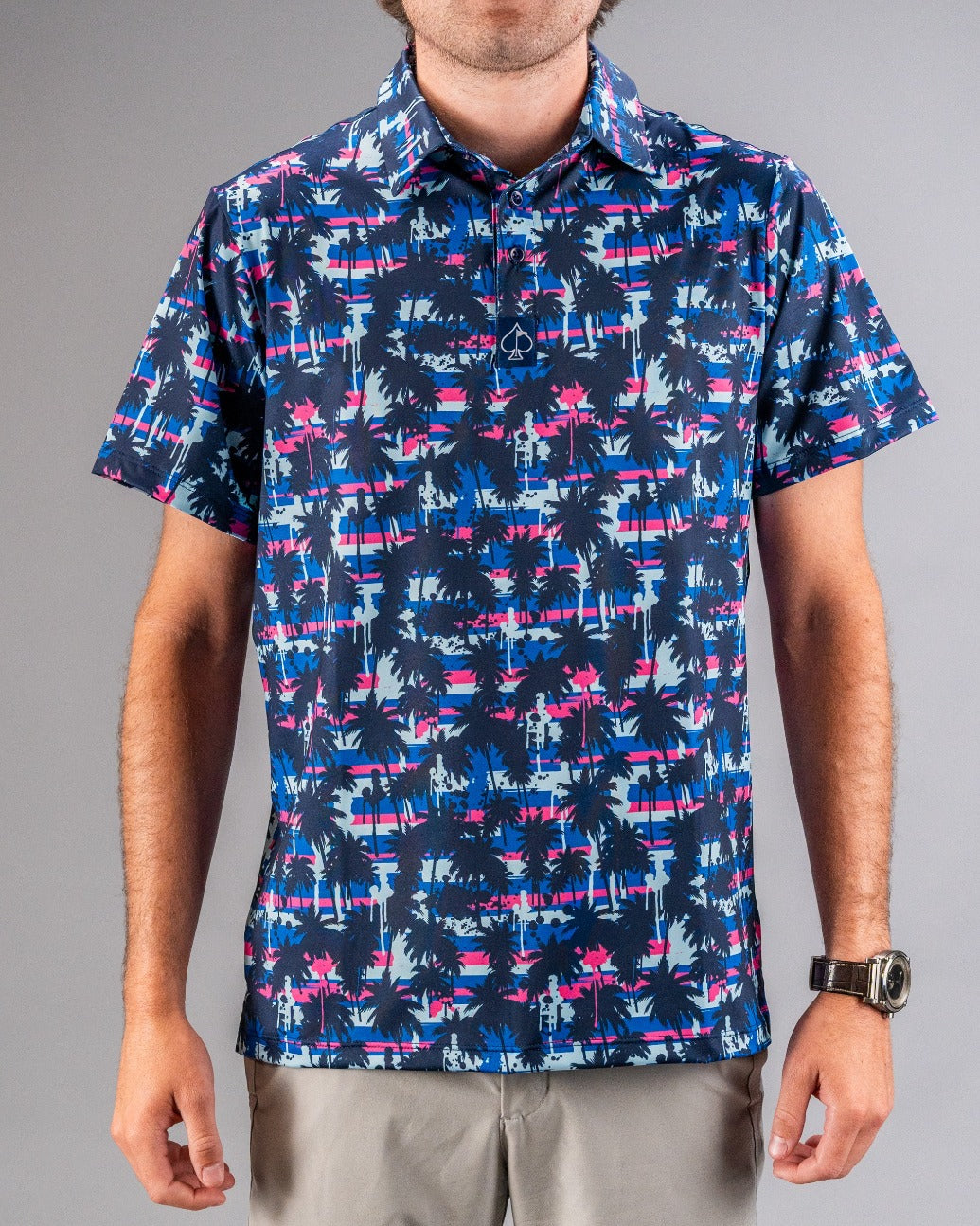 Bold golf shirt featuring a vibrant palm tree and sunset pattern, perfect for golfers wanting to stand out on the course.