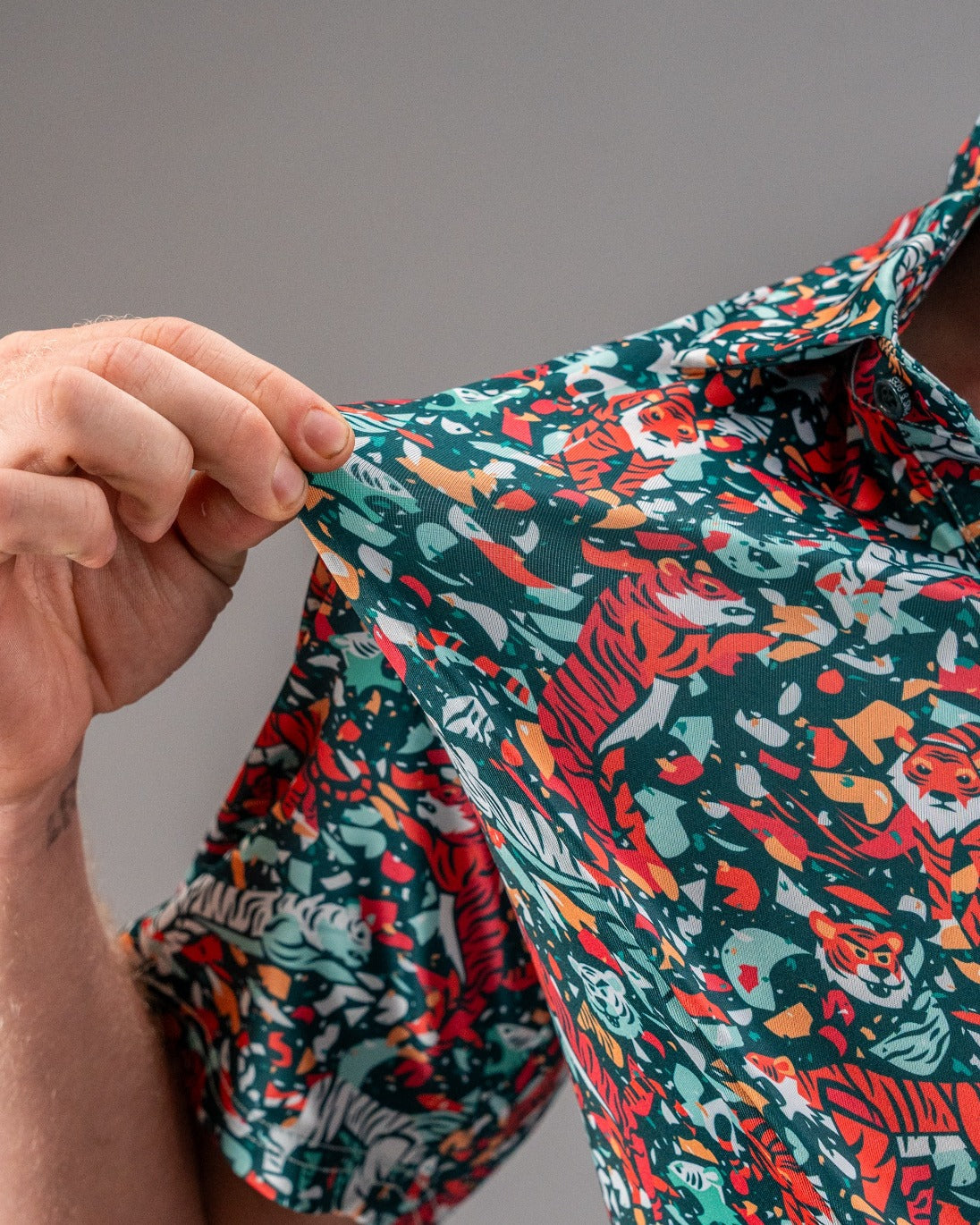 Bold teal golf shirt featuring a vibrant tiger print, perfect for golfers looking to make a statement on the course.