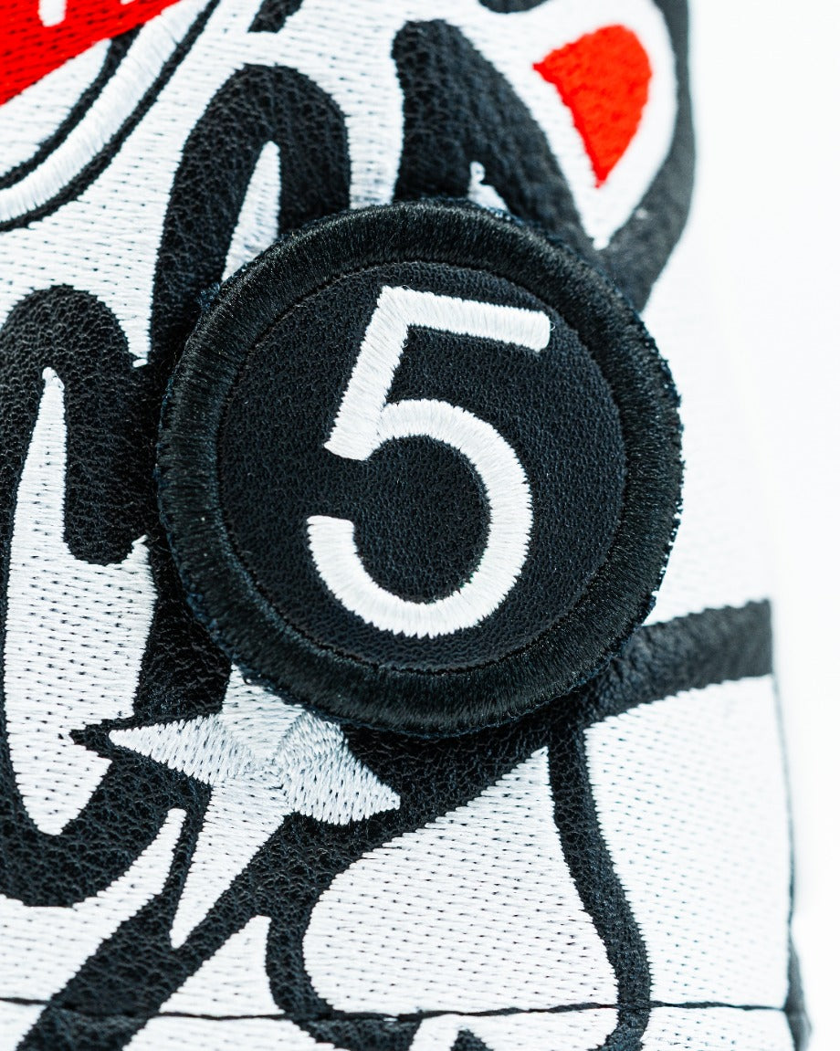 Black headcover patch featuring a bold white number five, designed for a stylish golf accessory.