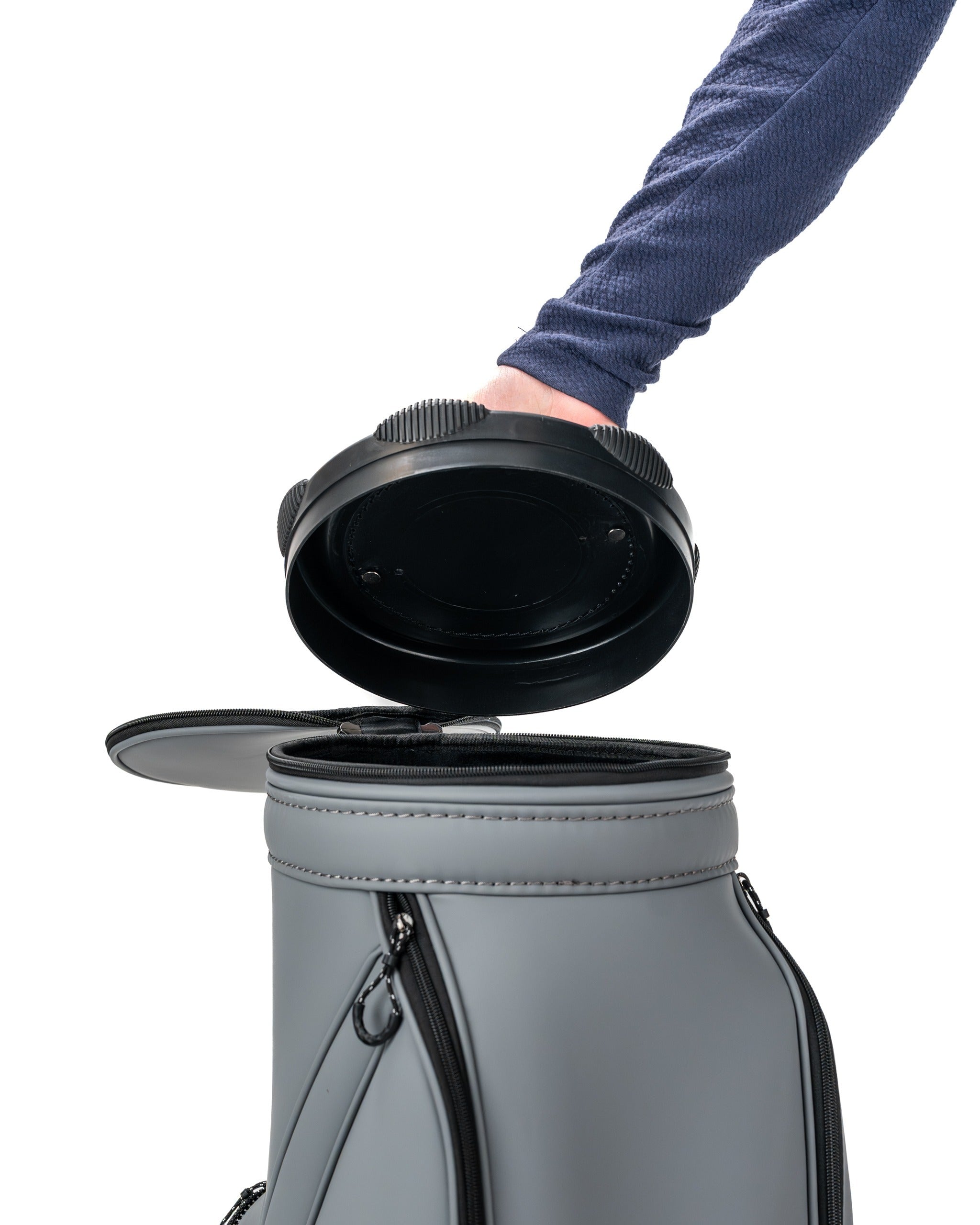 Stylish Den Caddy in flat ash color, showcasing a person opening the top lid for easy access to golf gear.