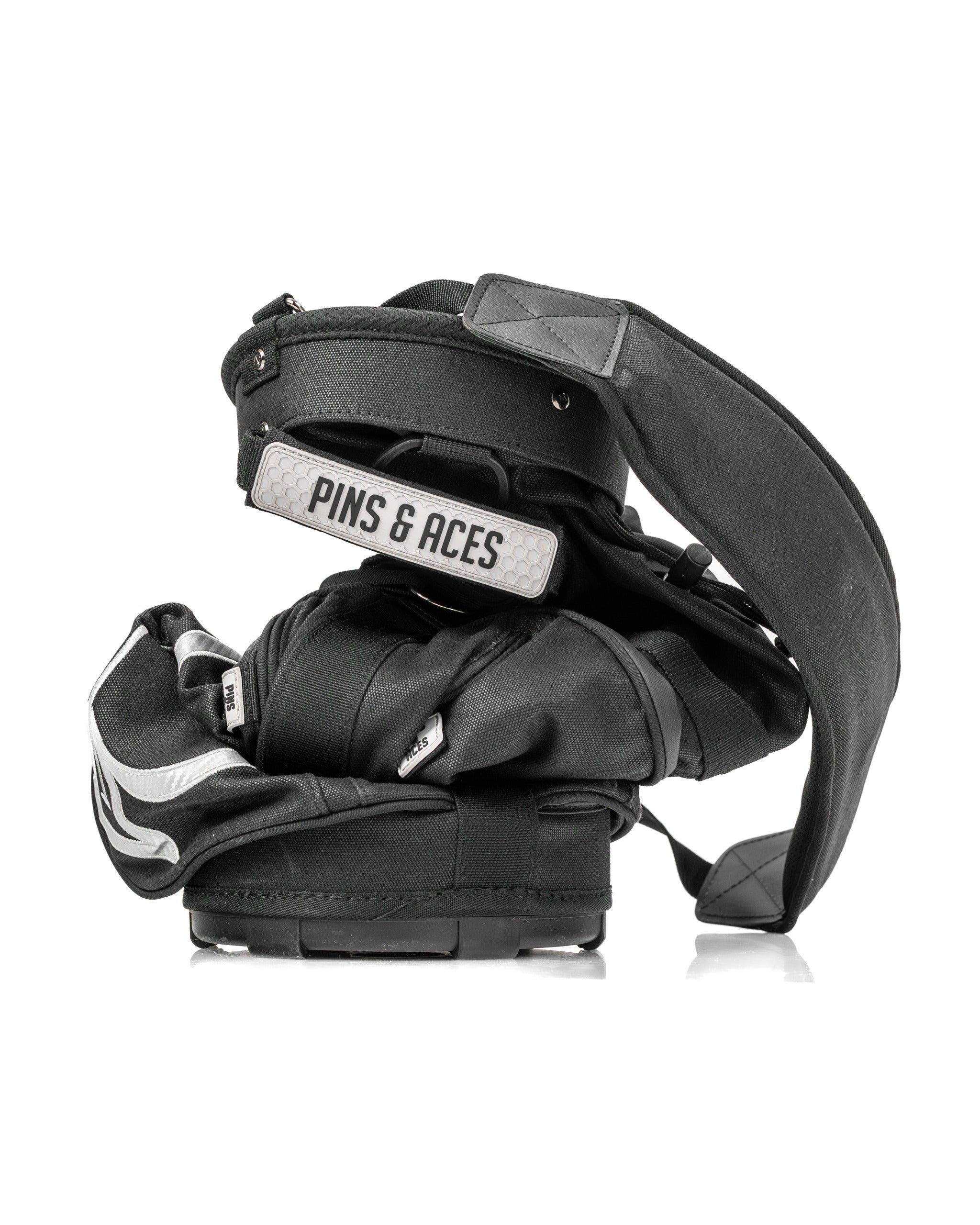 Compact Sunday golf bag in black with adjustable straps, designed for easy carrying on the course.