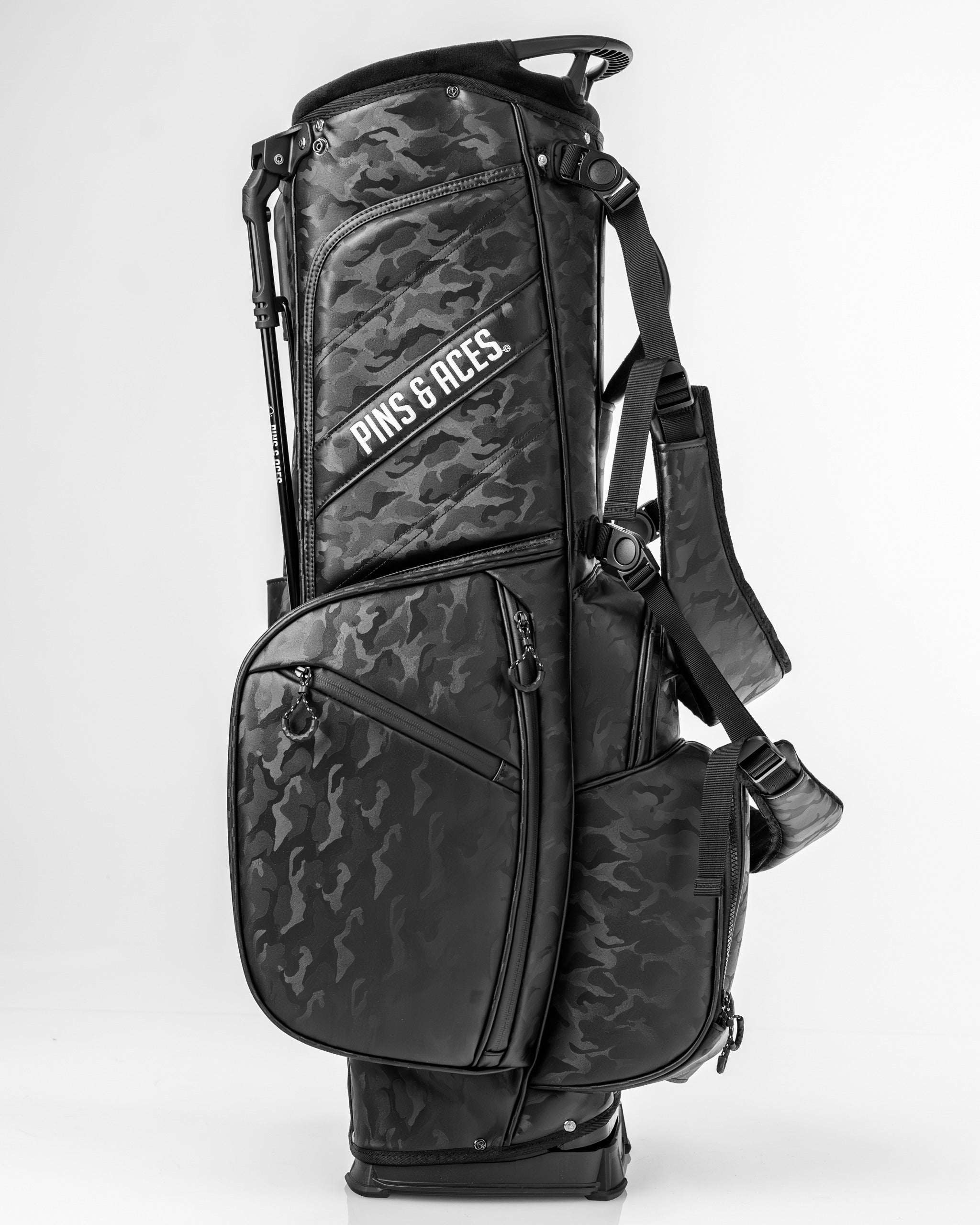 Black camo golf bag featuring multiple pockets and adjustable straps, designed for stylish golfers.