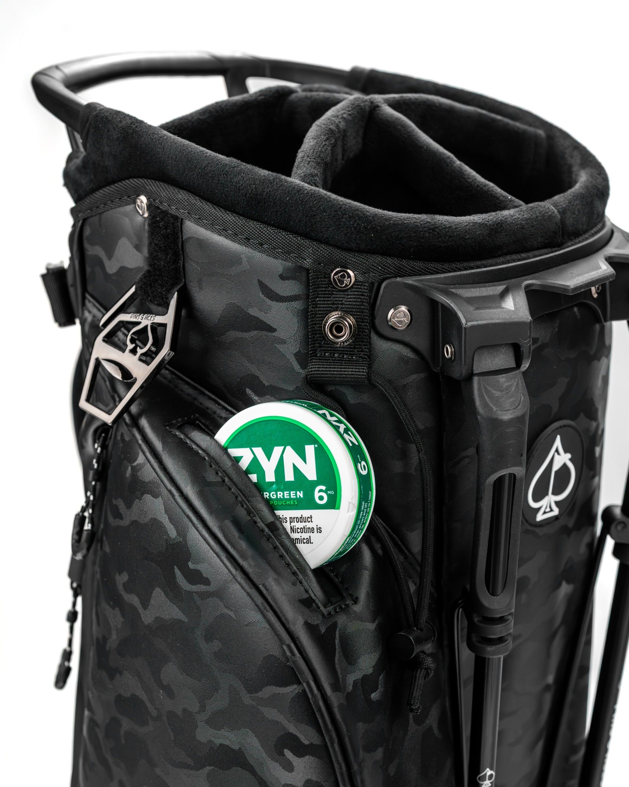 Black camo golf bag featuring a spacious top compartment and a side pocket for accessories, designed for stylish golfers.