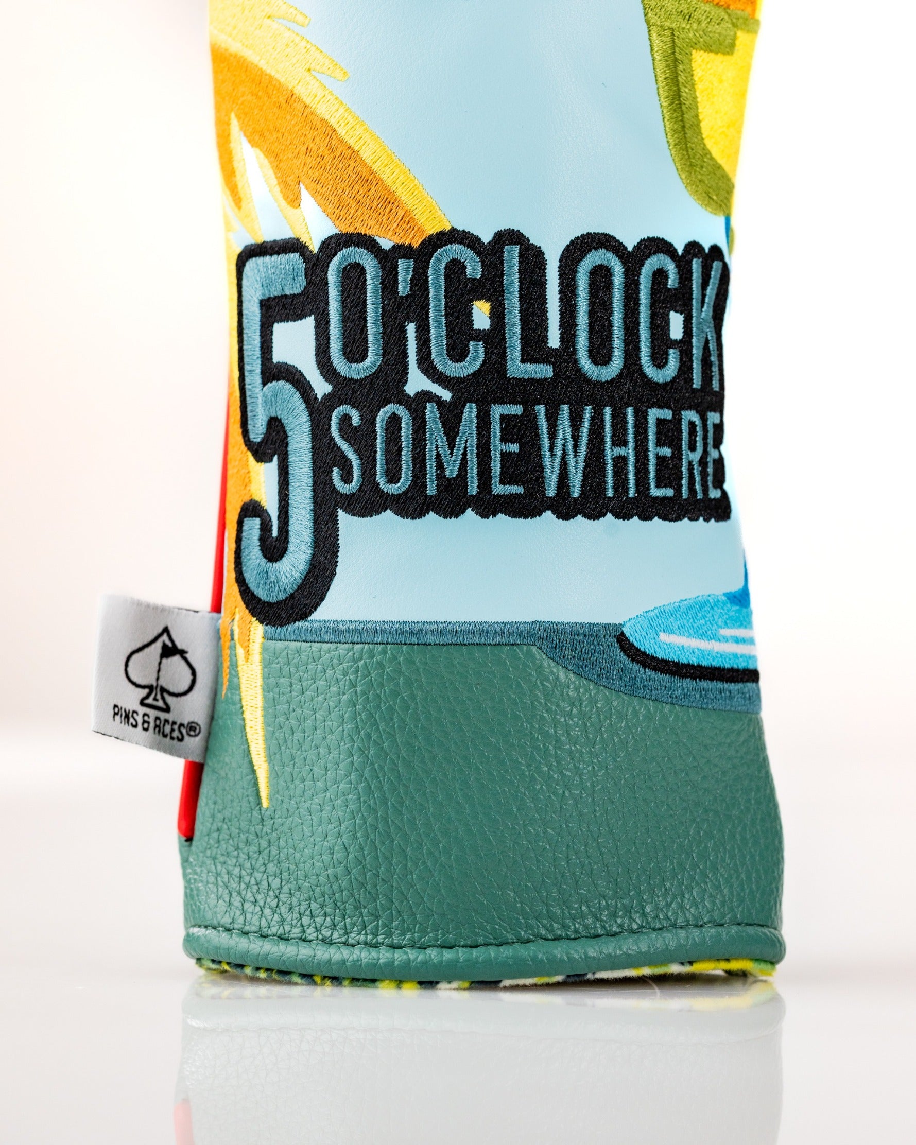 Colorful golf headcover featuring a tropical design and "5 O'Clock Somewhere" text, perfect for adding fun to your game.