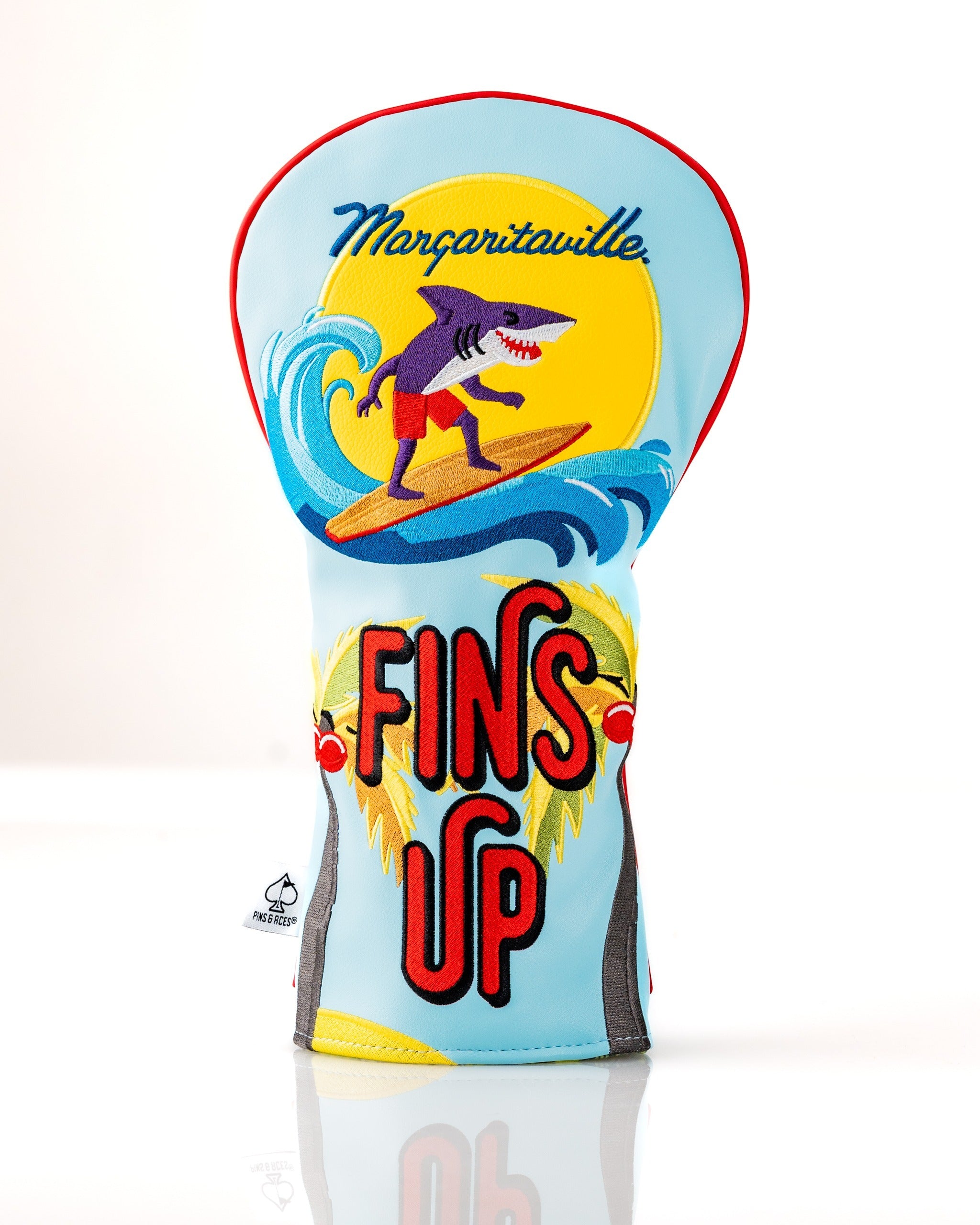 Colorful Margaritaville Fins Up driver cover featuring a surfing shark and vibrant tropical design for stylish golf protection.