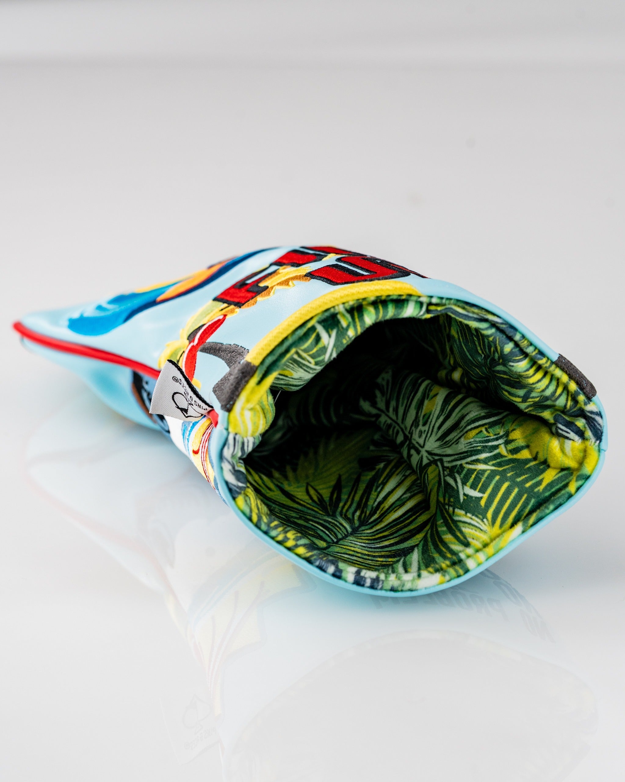 Vibrant Margaritaville Fins Up driver cover featuring tropical designs and a leafy interior for stylish golf protection.