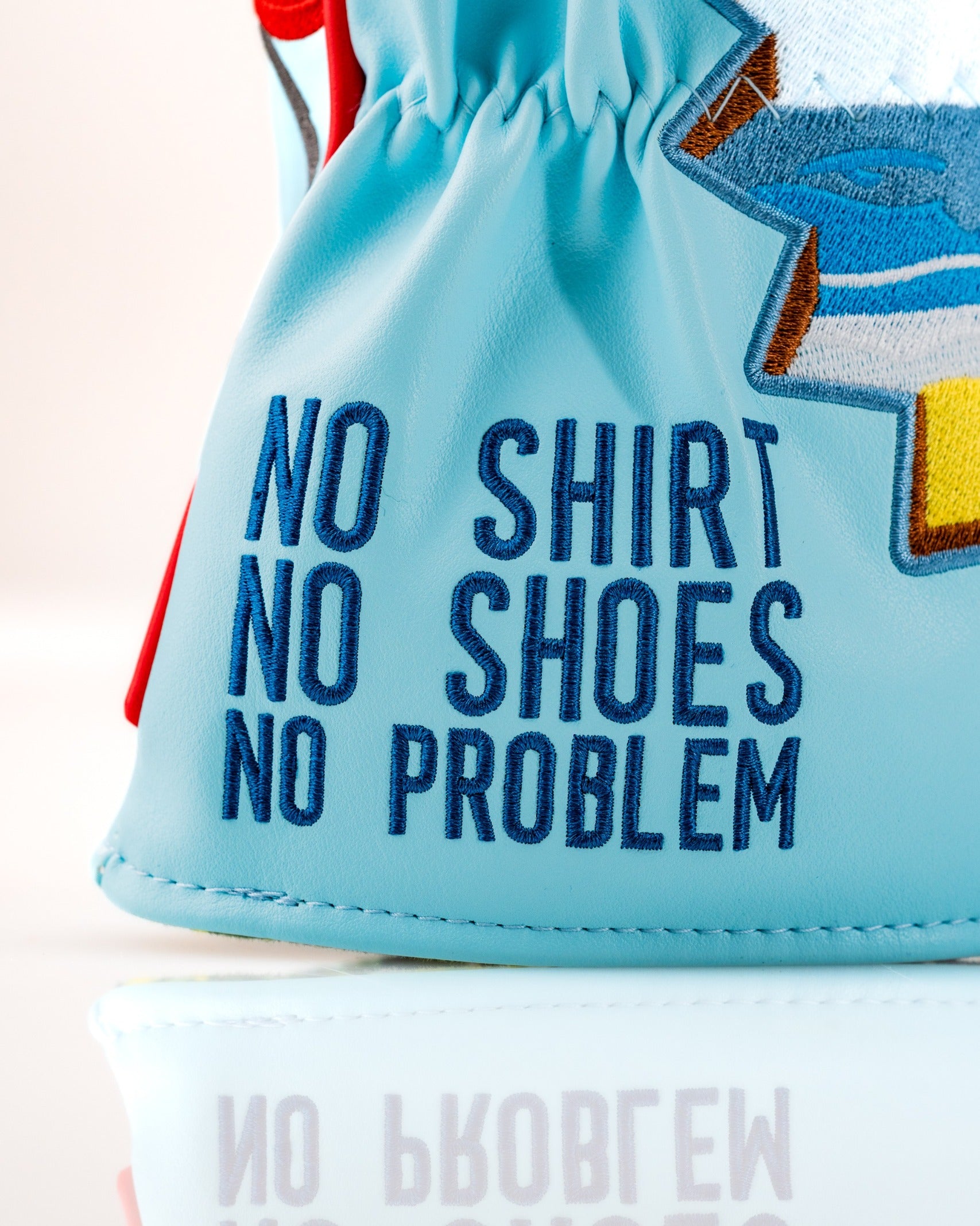 Margaritaville Fins Up driver cover featuring colorful beach-themed design and embroidered "No Shirt No Shoes No Problem" text.