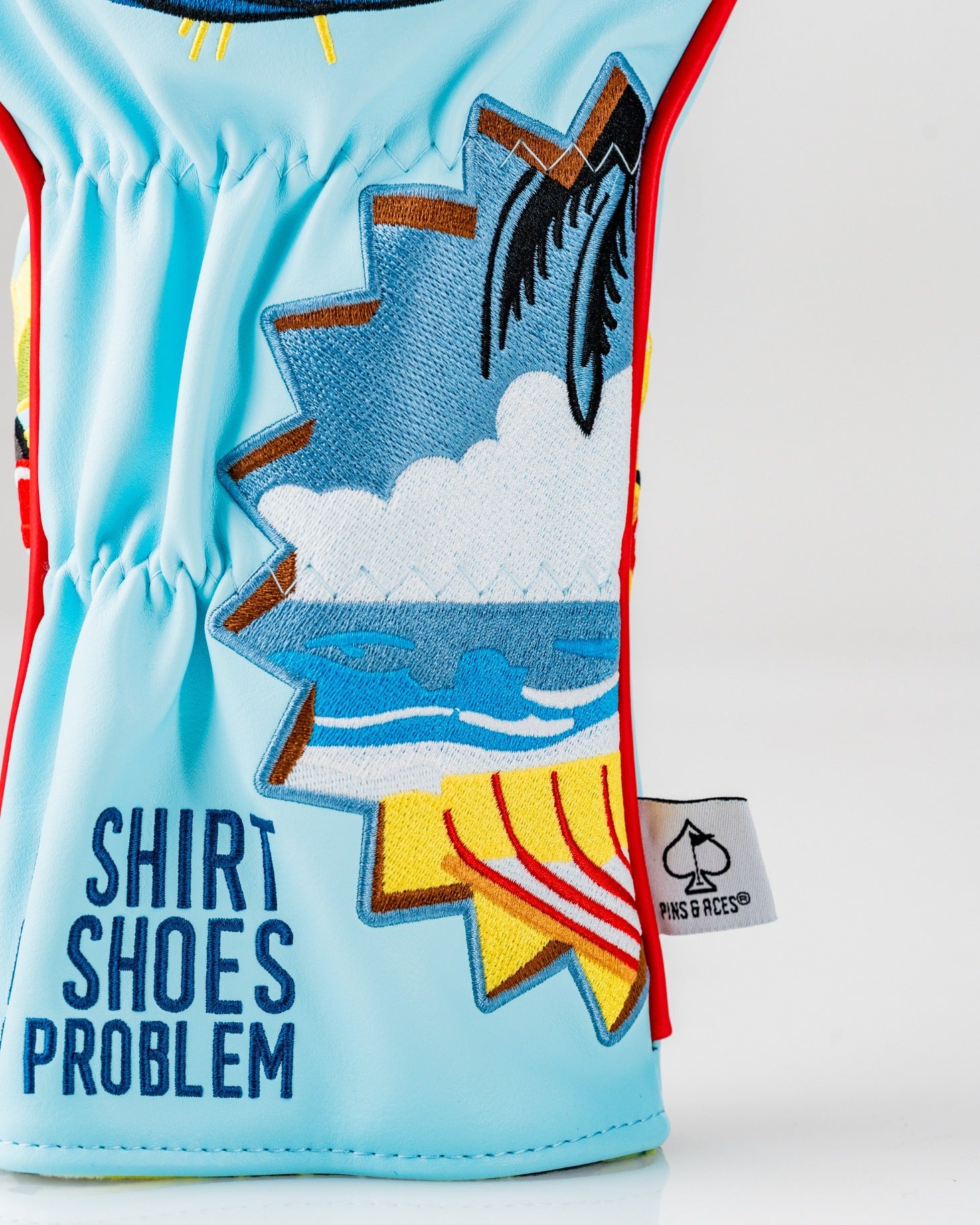 Colorful Margaritaville Fins Up driver cover featuring beach and palm tree graphics with "Shirt Shoes Problem" text.