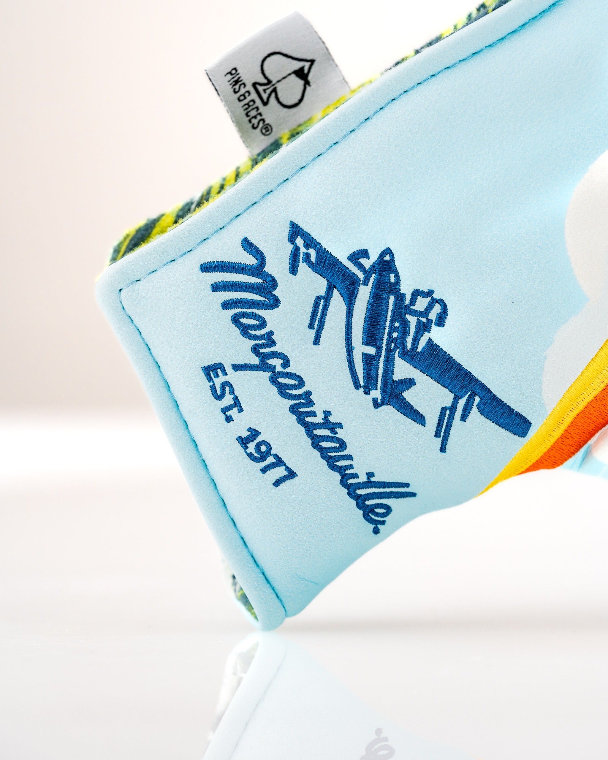 Colorful Margaritaville Puddle Jumper blade putter cover featuring a vintage airplane design and established date.
