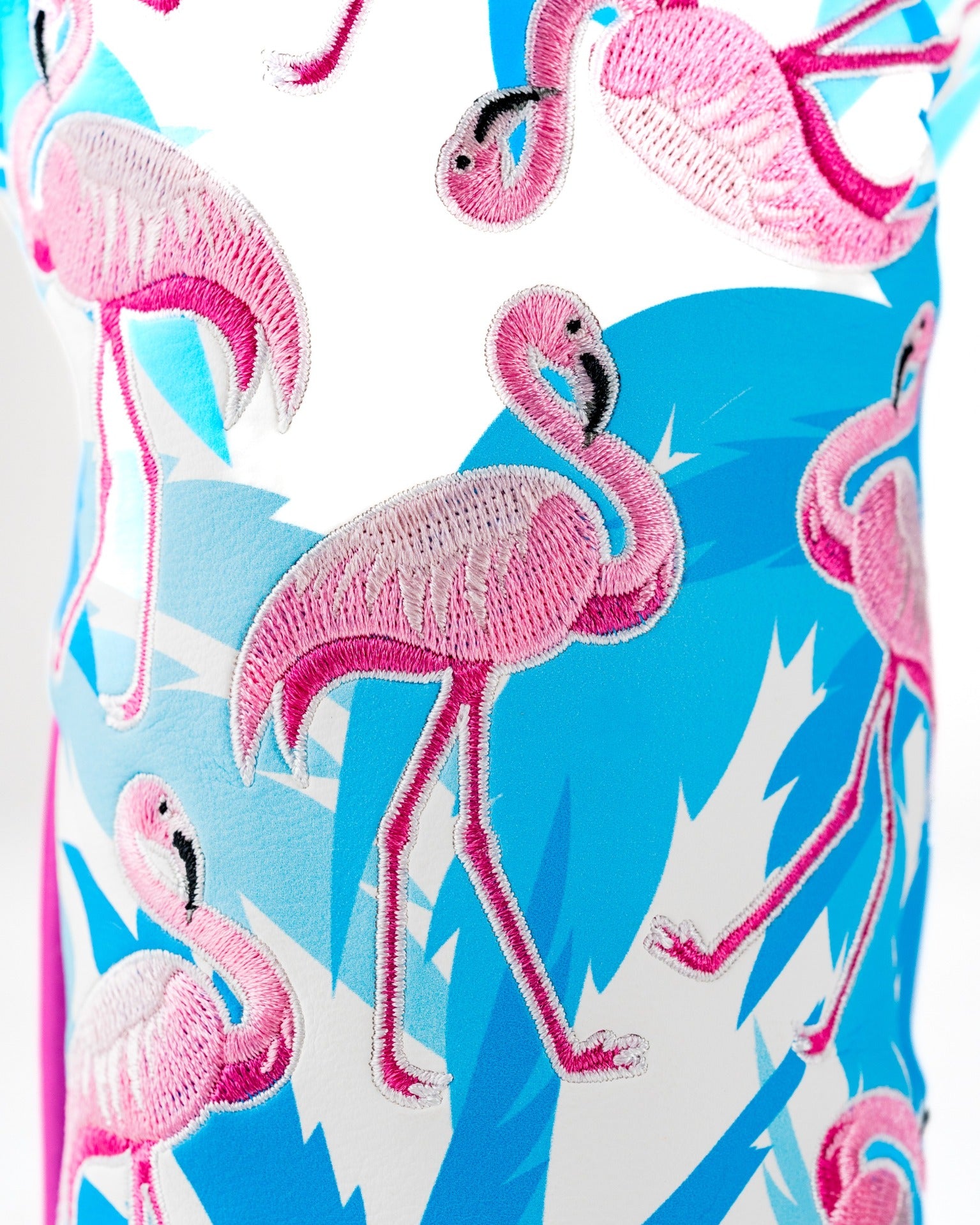 Colorful fairway cover featuring vibrant pink flamingos on a blue and white background, perfect for stylish golfers.