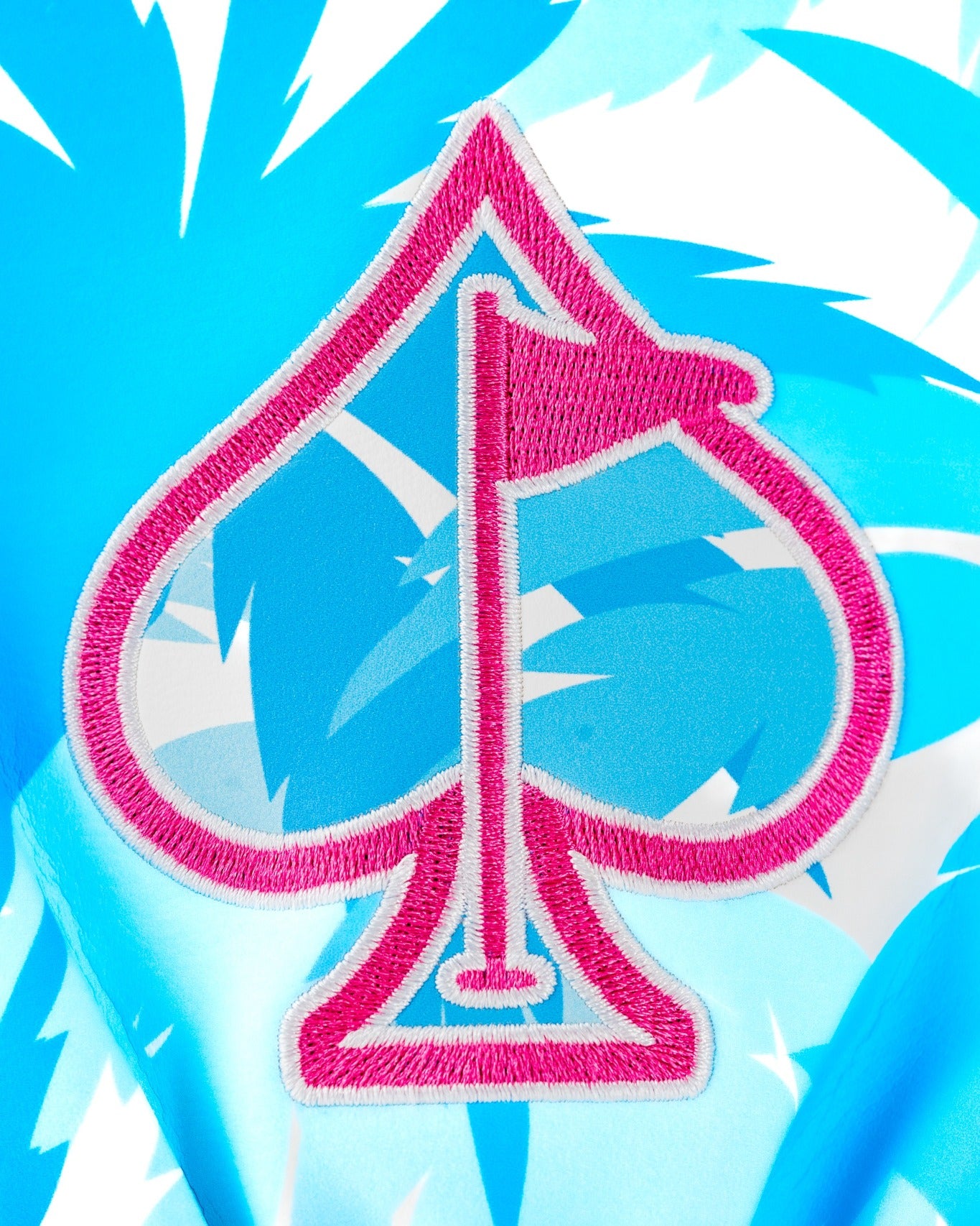 Bright blue driver cover featuring a pink spade logo with a flag, designed for golfers seeking bold style on the course.