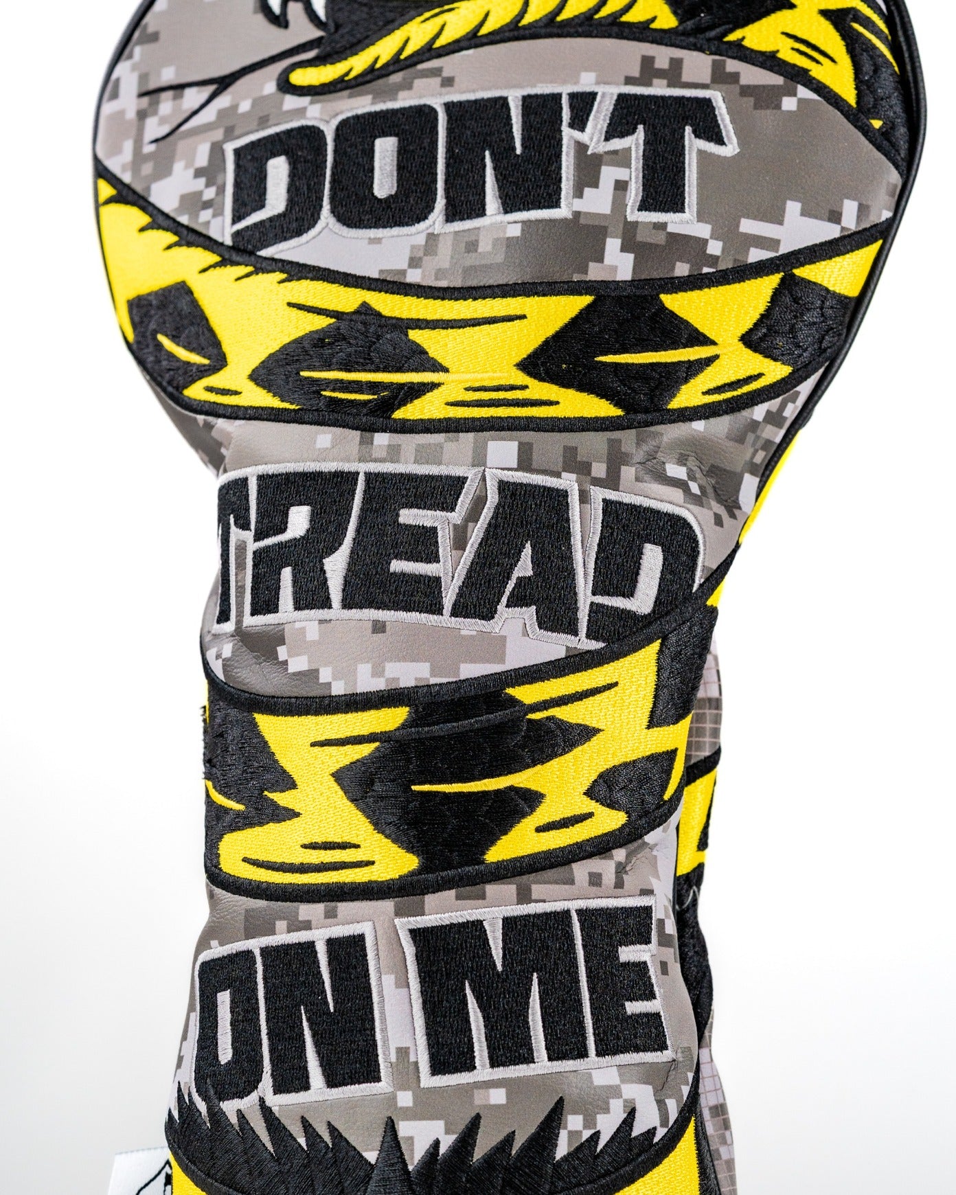 Bold "Don't Tread On Me 2.0" driver cover featuring a striking yellow and black design on a camouflage background.