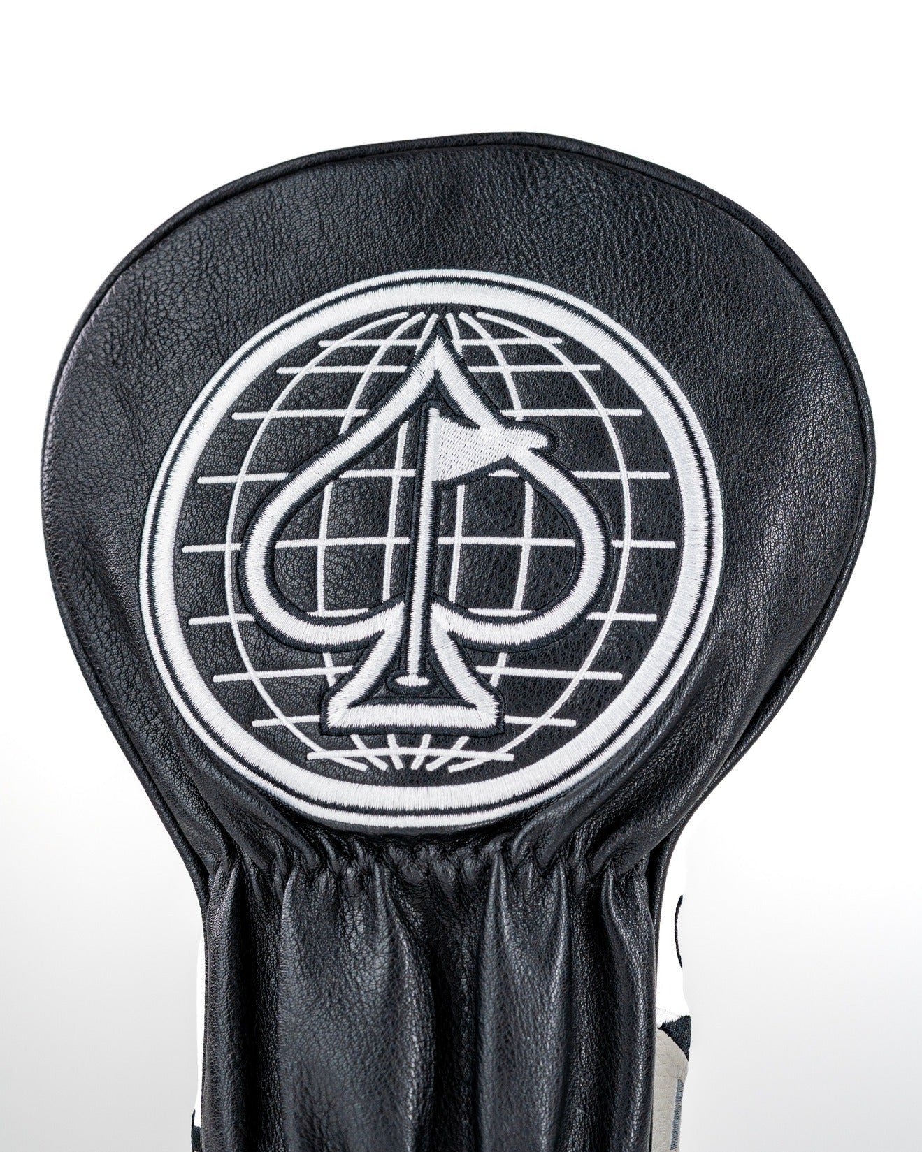 Black leather driver cover featuring a bold spade logo and globe design, perfect for stylish golfers.