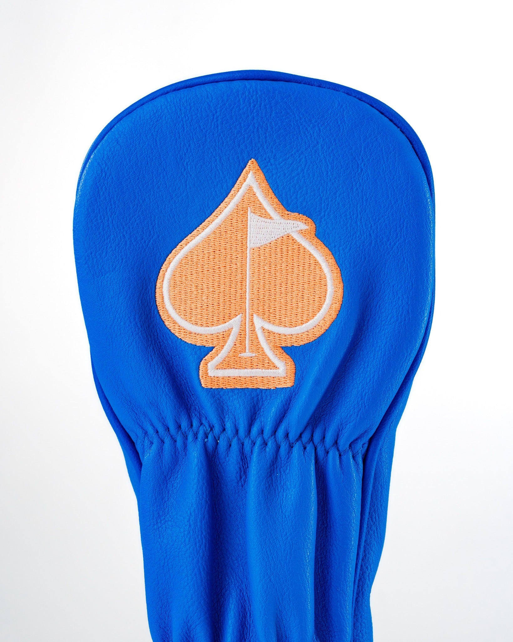 Bright blue golf headcover featuring an orange spade logo with a flag, designed for a fun and unique style on the course.