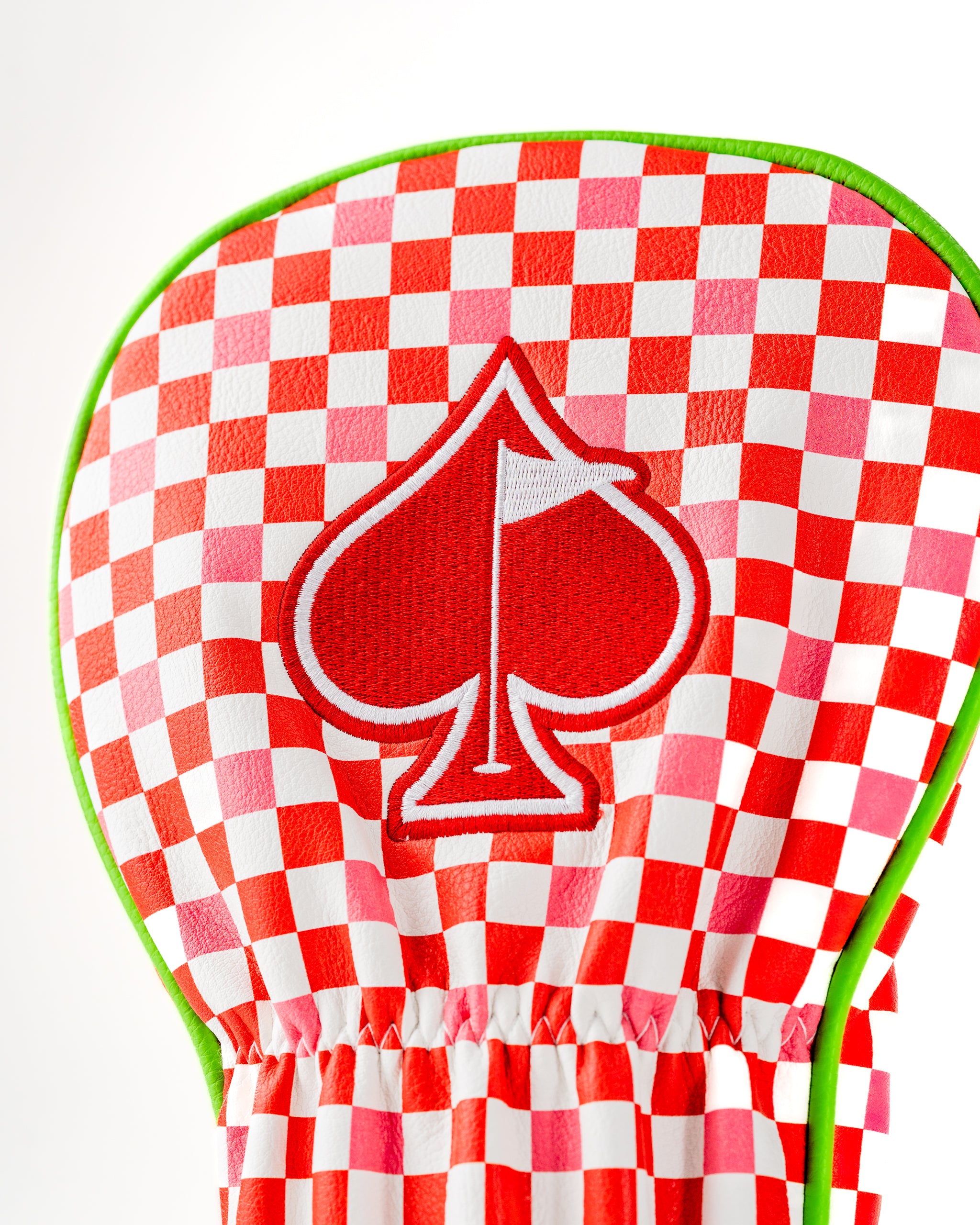 Bold red and white checkered driver cover featuring a prominent red spade emblem, designed for stylish golfers.