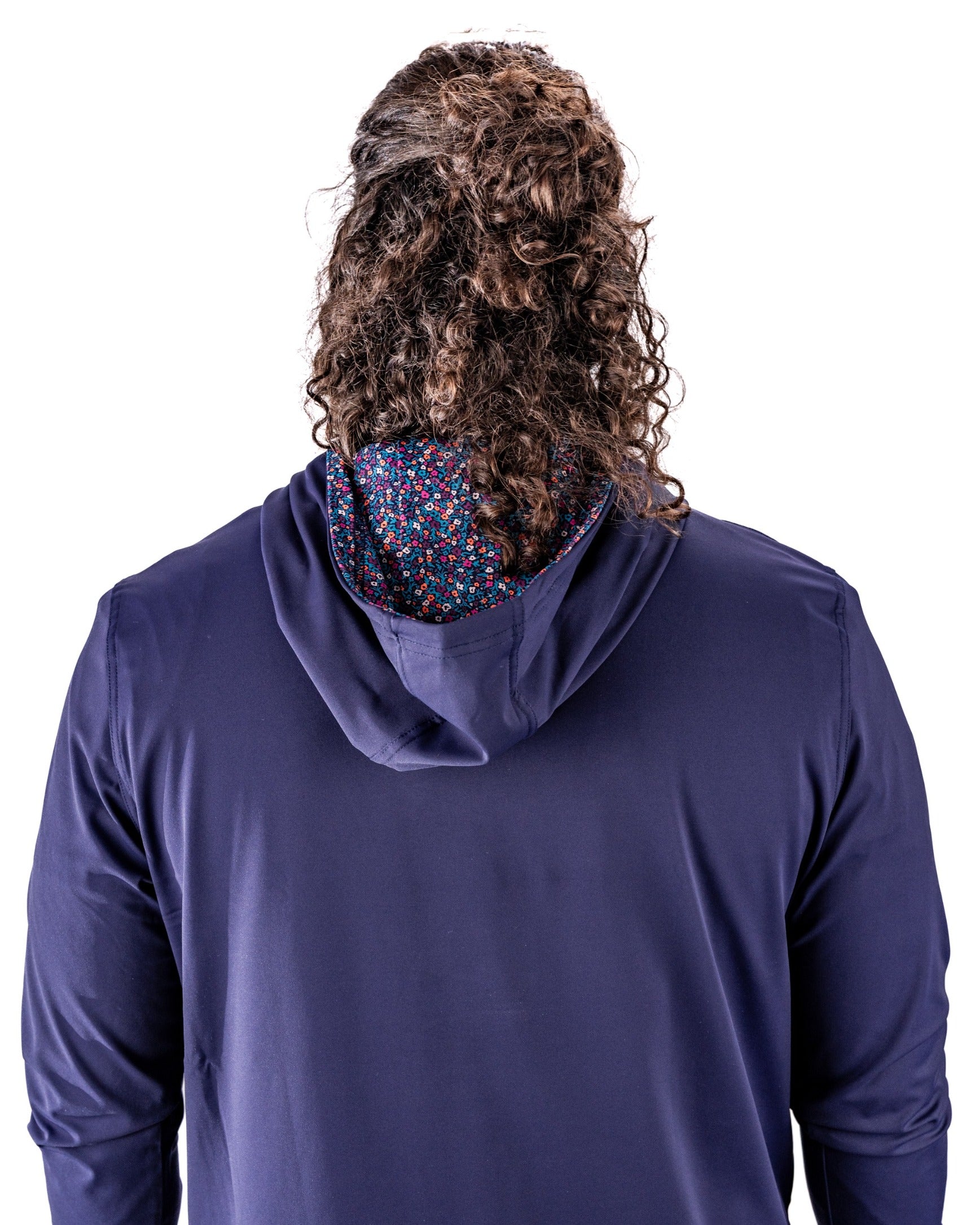 Back view of a lavender performance golf hoodie featuring a vibrant floral-patterned interior lining. Ideal for stylish golfers.