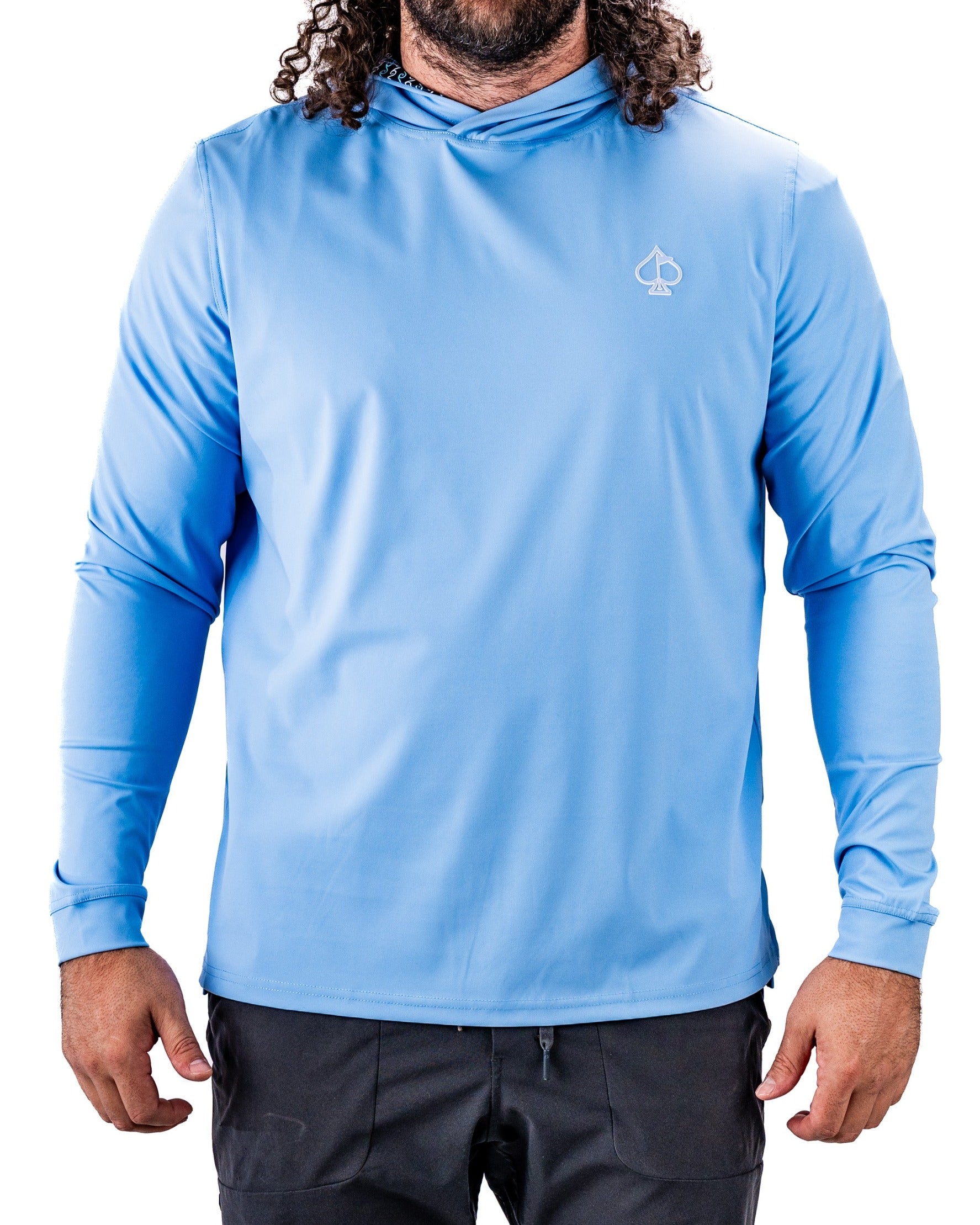 Light blue performance golf hoodie with a hood and long sleeves, featuring a small logo on the chest, ideal for golfers.