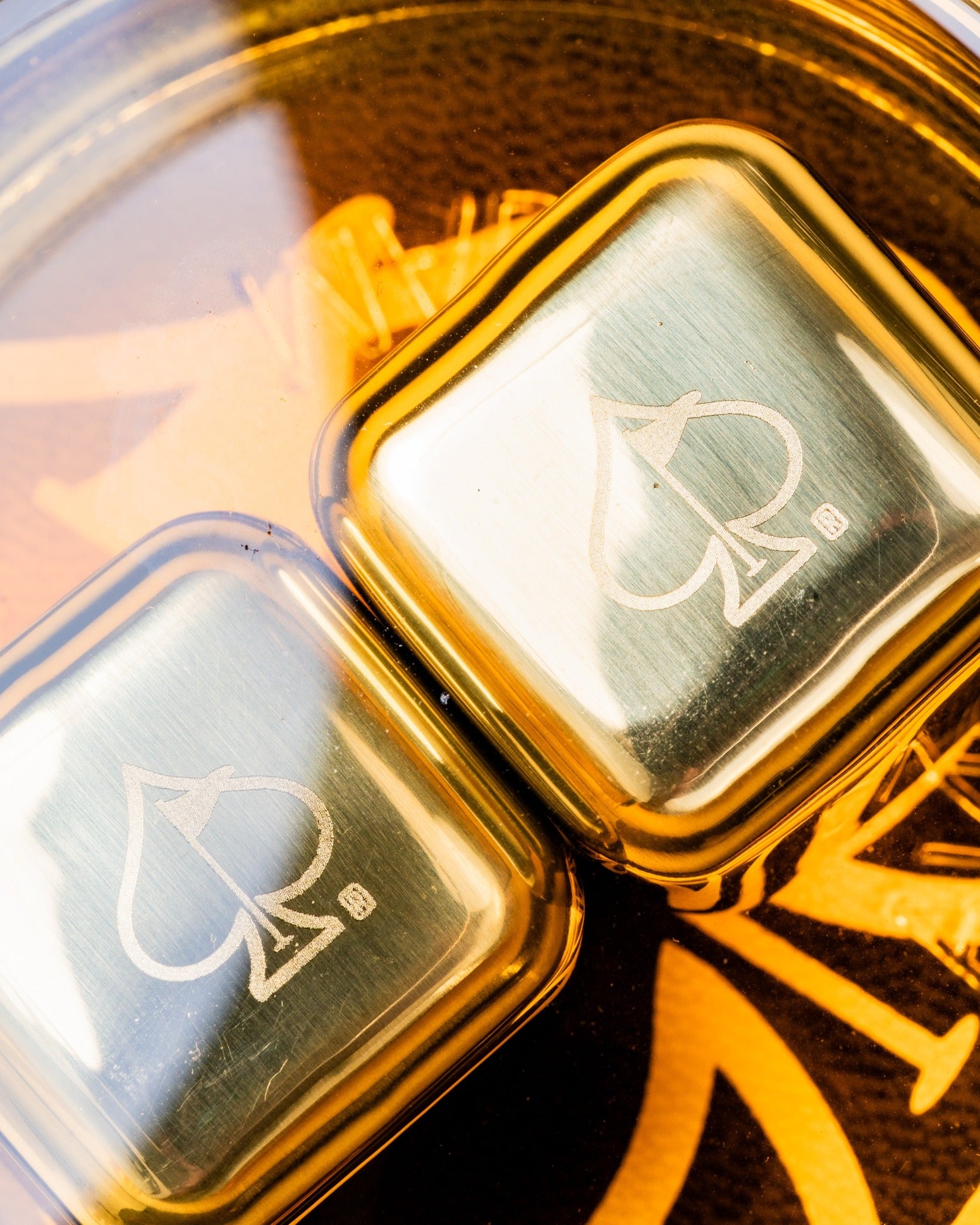 Set of two whisky glasses featuring a sleek design with an engraved spade logo, perfect for enjoying your favorite spirits.