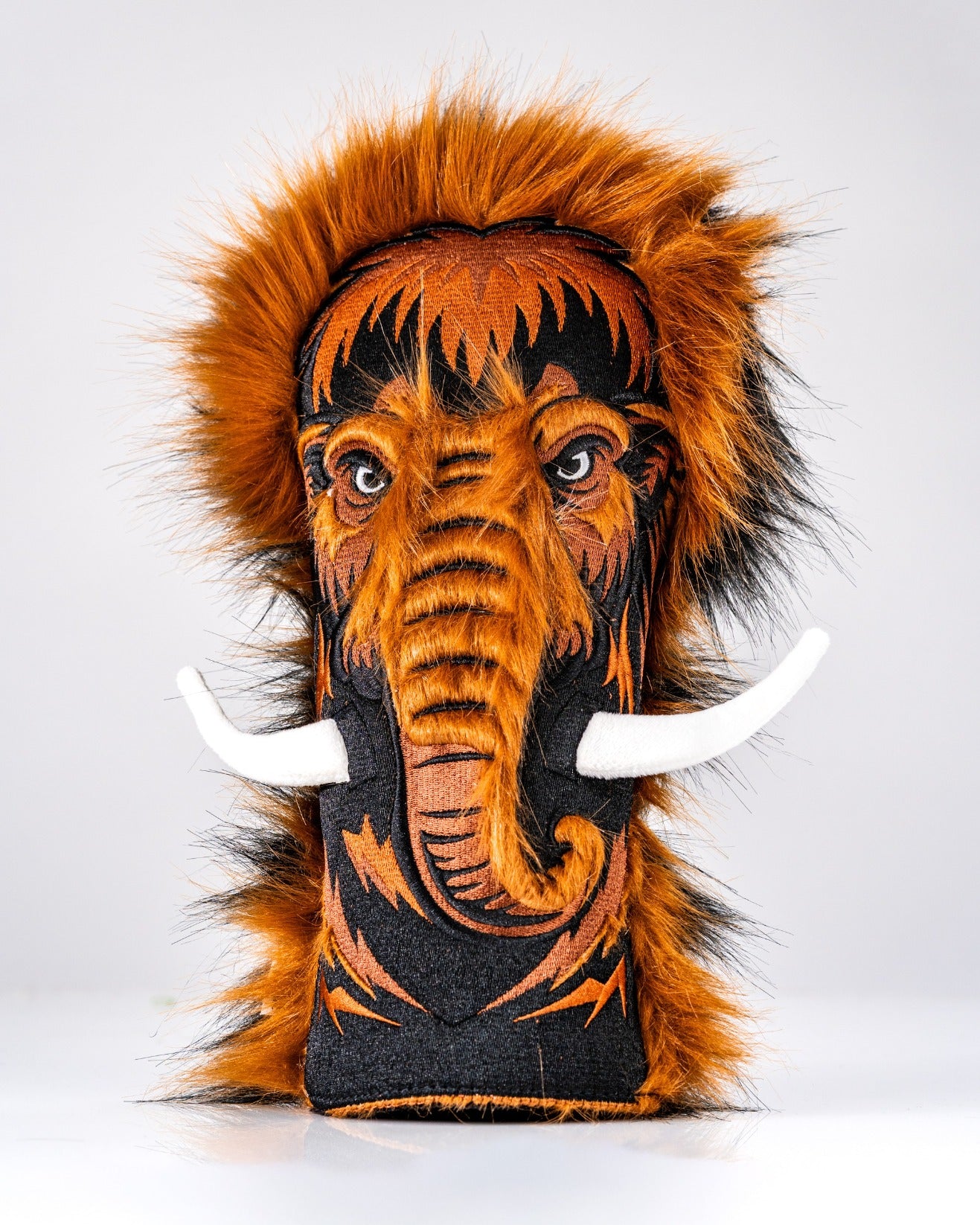 Bold woolly mammoth driver cover featuring vibrant orange and black fur, detailed facial design, and white tusks.