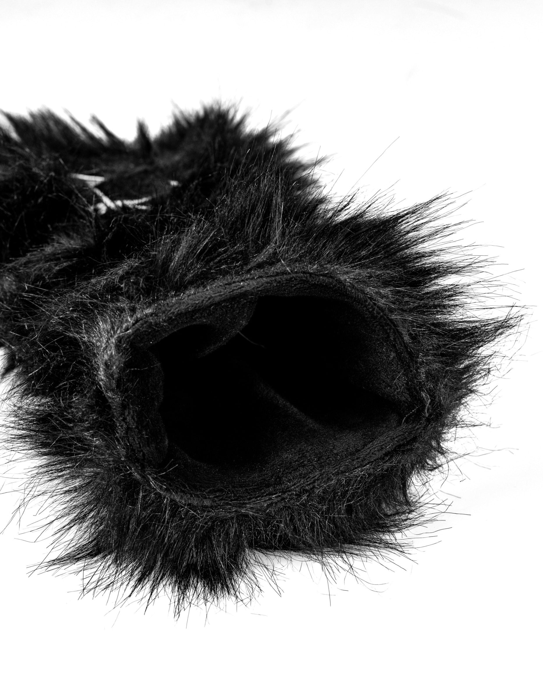 Black furry driver cover designed to resemble a panda, featuring a soft interior for club protection.