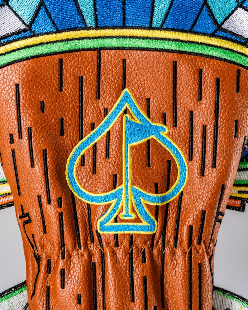 Tiki fairway cover featuring a vibrant design with a brown textured background and a blue spade logo.