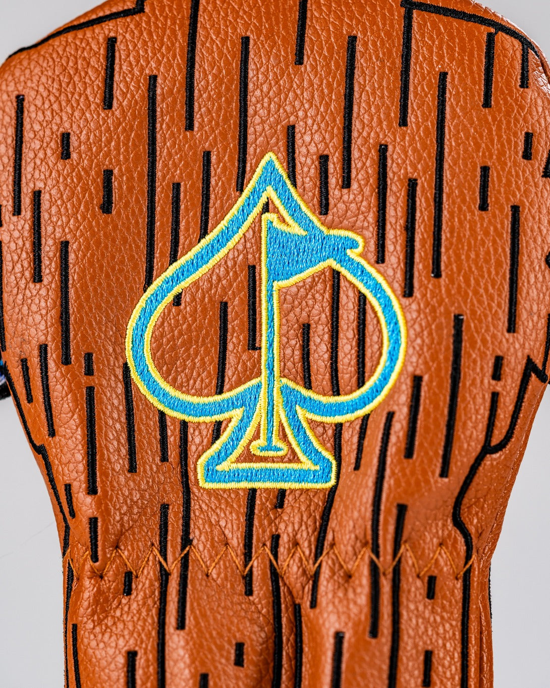 Tiki hybrid cover featuring a wood grain design and a blue spade emblem, perfect for stylish golfers.